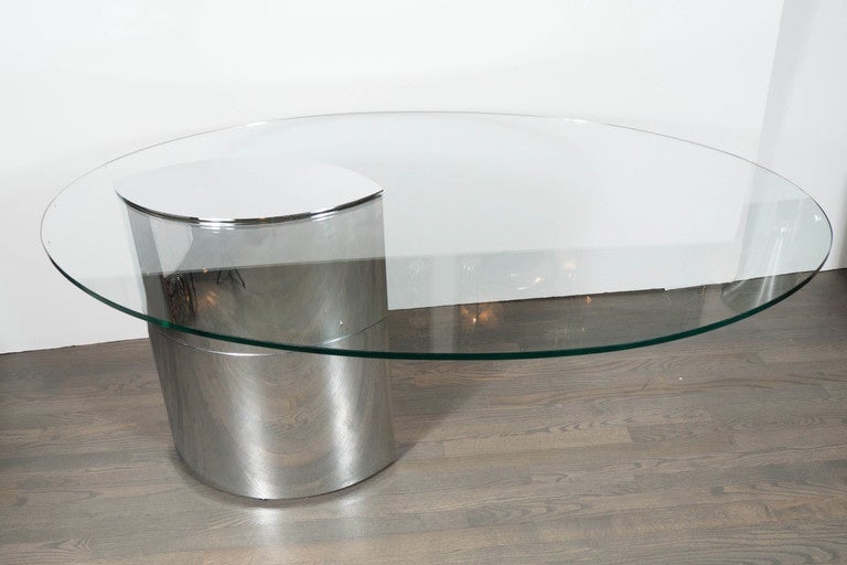 This Mid-Century Modernist Cini Boeri Lunario desk/table by Gavina for Knoll features an elliptical shaped half inch piece of glass that is cantilevered from its chromed weighted base, also in an elliptical shape. The chromed base has a top piece