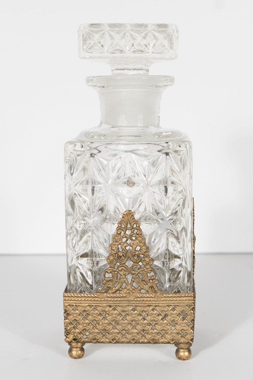 This gorgeous perfume bottle features a gilt stand holding a carved glass perfume bottle with a cross hatched diamond design . This perfume bottle is in excellent condition and would make a great accessory .
