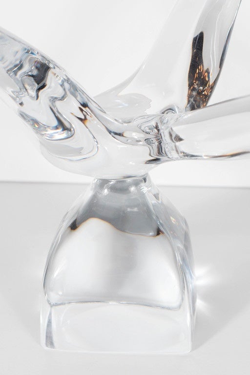 This stunning crystal sculpture by Daum features an elegant bird in flight. This piece is also signed Daum France on the side of the base.