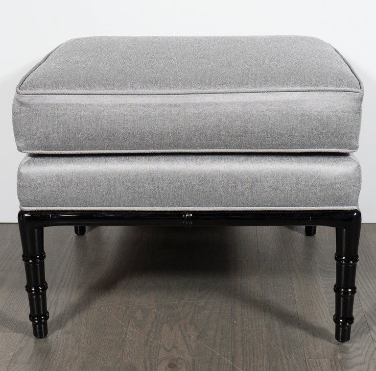This gorgeous bench features a stylized bamboo leg and support design. It has been newly upholstered in a platinum sharkskin upholstery with ebonized walnut legs and supports. This bench is in the manner of William Haines and has been mint