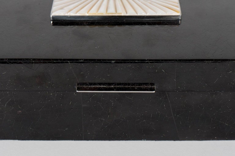 Lux Blacktab Shell box with textured Allan Shell overlay and Tahiti Shell pyramid centerpiece with Streamlined Silvered linear handle.  This Blacktab Shell box is featured in a square shape with a lidded closure top that is adorned with a square