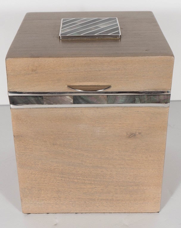 An exquisite bleached mahogany tall box with mother-of-pearl trim and inlaid  top with silvered trimmings. This high box is comprised of bleached Mahogany and a closure lid top that is trimmed with silvered inlay that outlines the Tahiti shell
