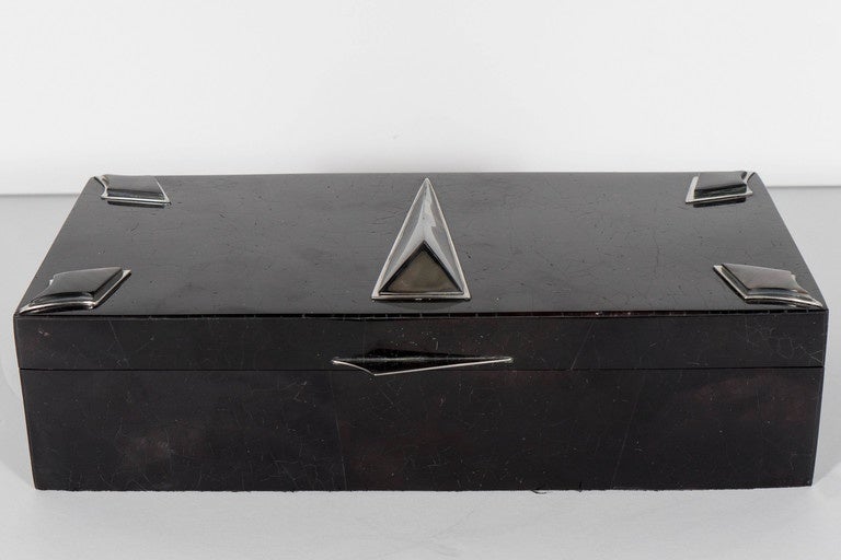 This superb box features arrowhead shaped mother-of-pearl inlays in each of the lid corners as well as a raised triangular inlay adorning the center. The box also includes a shark-fin shaped latch fabricated in lustrous nickel, a black felt interior