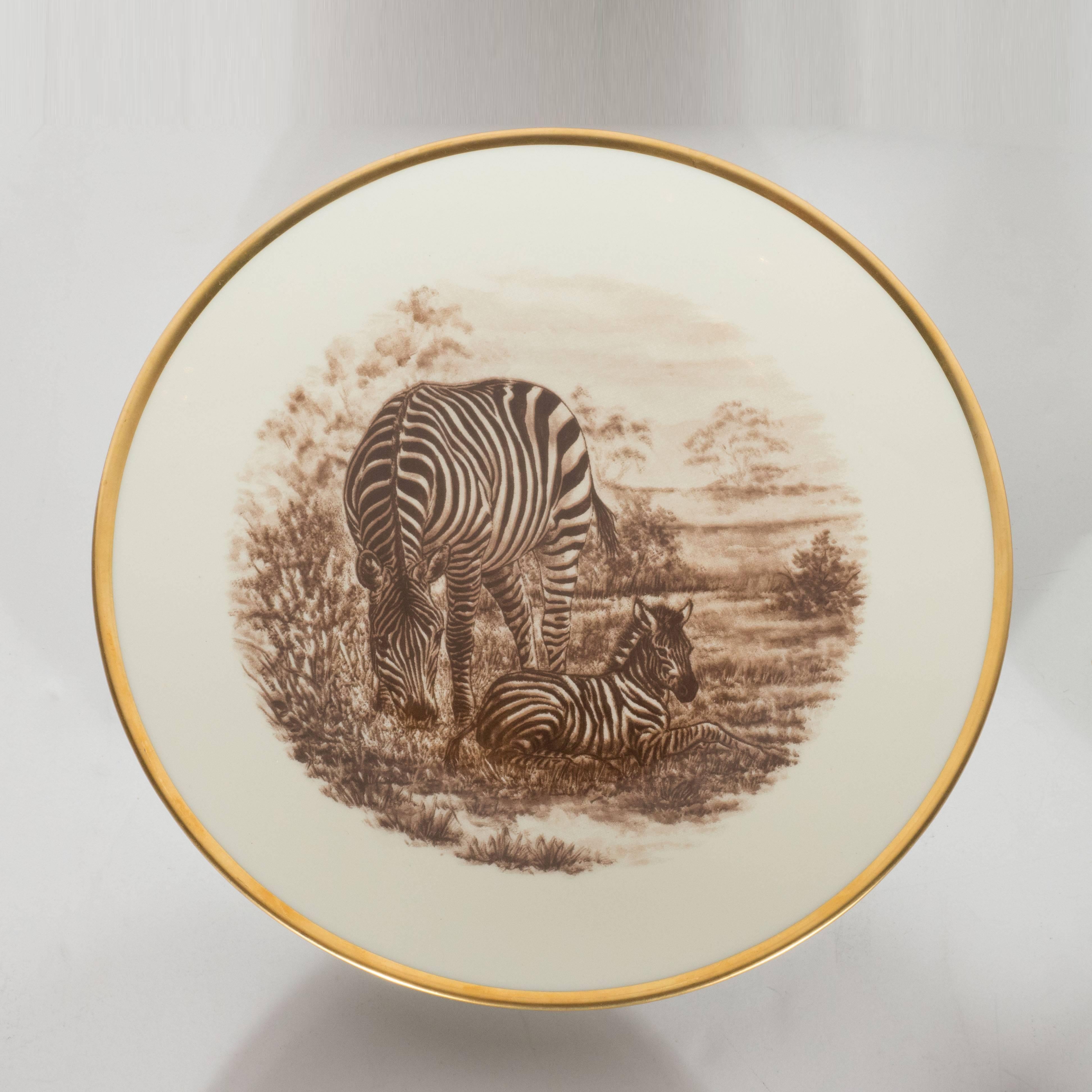 This elegant and whimsical set of six Safari themed plates by the legendary French porcelain manufacturer Limoges features six different kinds of animals from the African savanna- giraffes, monkeys, lions, zebras, cheetahs and elephants- in sepia