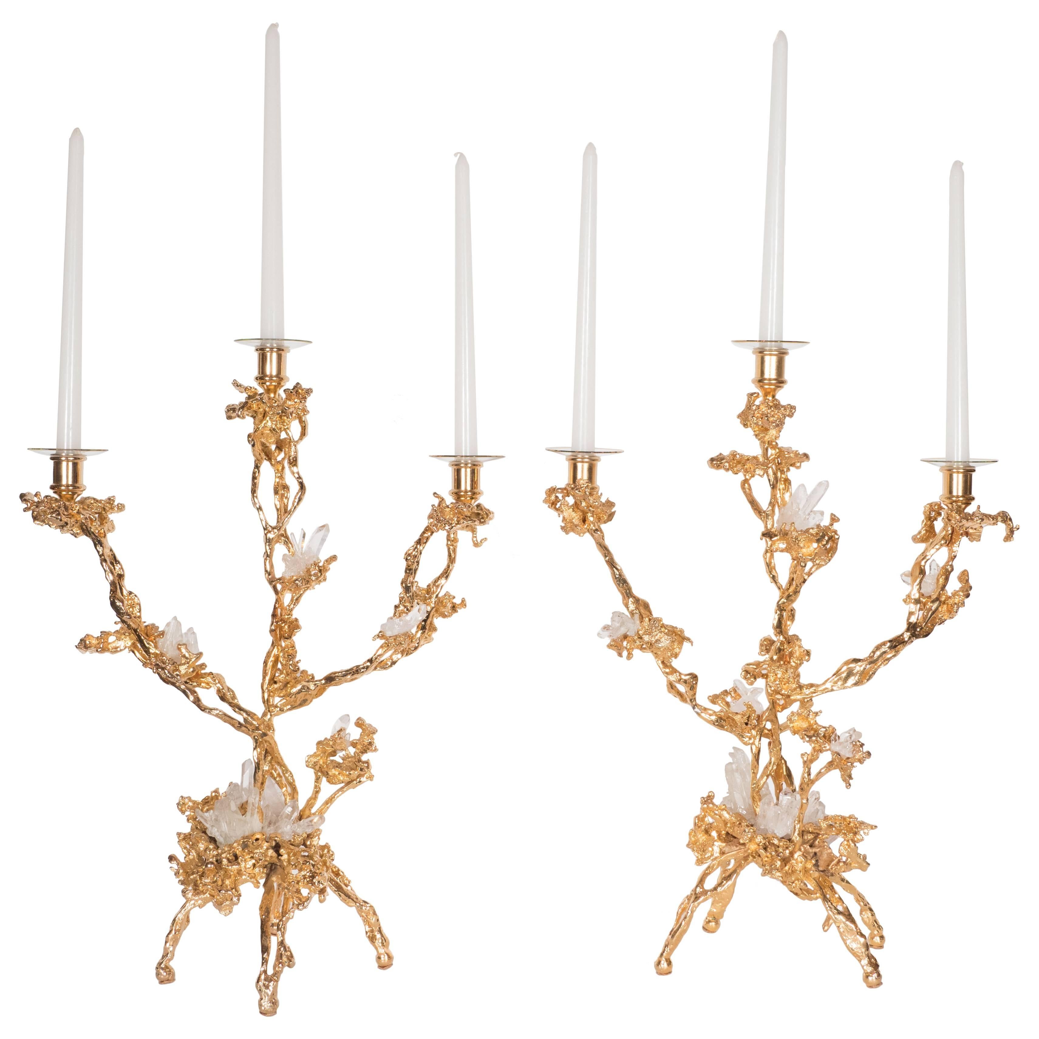 These stunning Mid-Century Modern candlesticks were realized in France circa 1970 by the esteemed artisan Claude Victor Boeltz. They offer an exploded form sculpted, by hand, and cast in bronze, consisting of three arms and four feet feet,