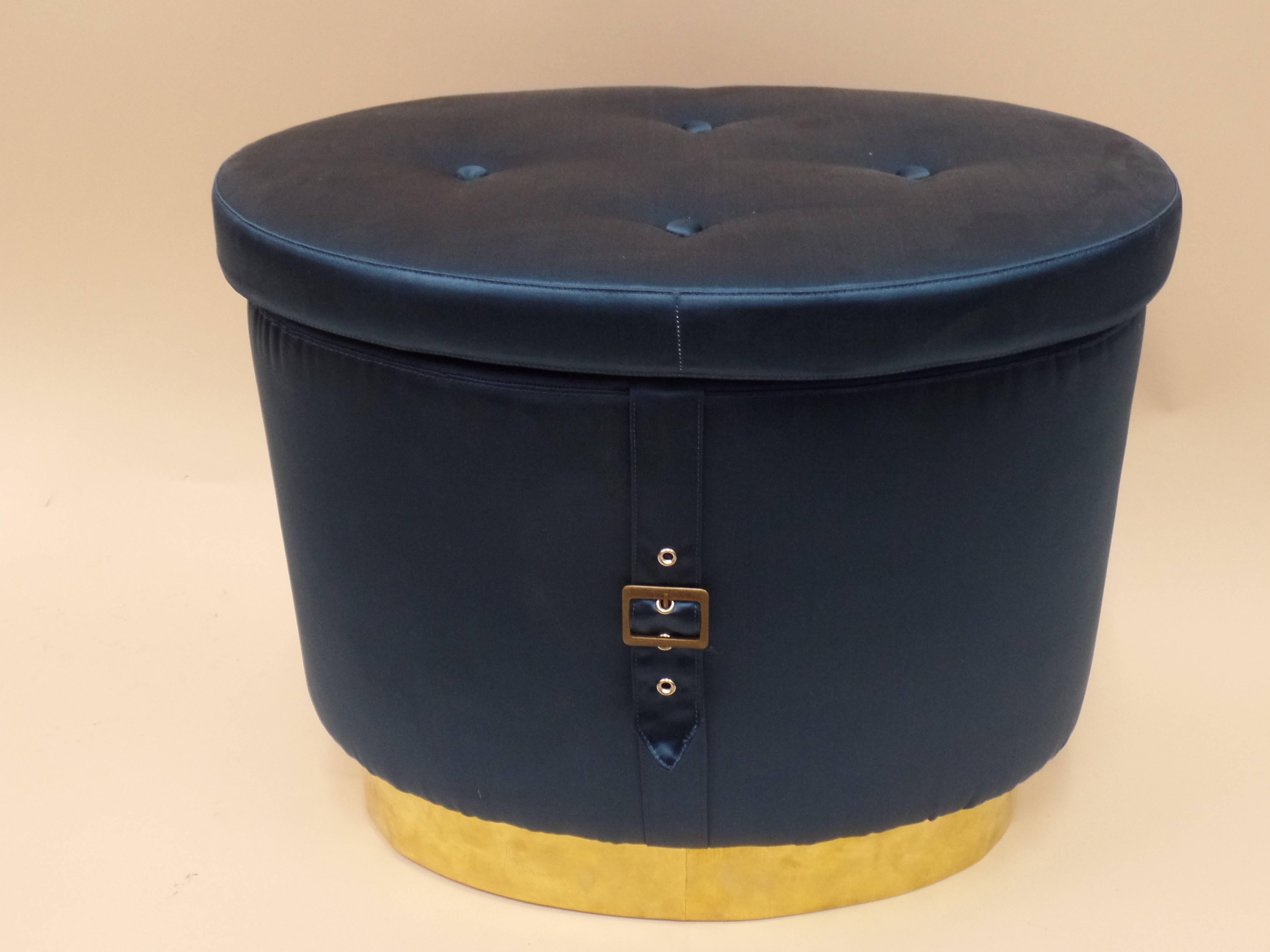 Stunning pair of Italian 1970s oval form stools, ottomans, poofs or benches with a recessed brass base, tufted silk seats and a belt with brass buckle that forms a crest on the central apron!