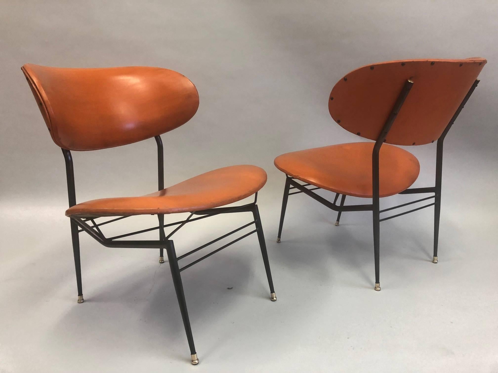 Two pairs of Important Italian Mid-Century Modern lounge chairs / armchairs / slipper chairs by Gastone Rinaldi. These stunning.pieces have a rare, architectural presence and are composed of an enameled steel frame finished with brass caps on the