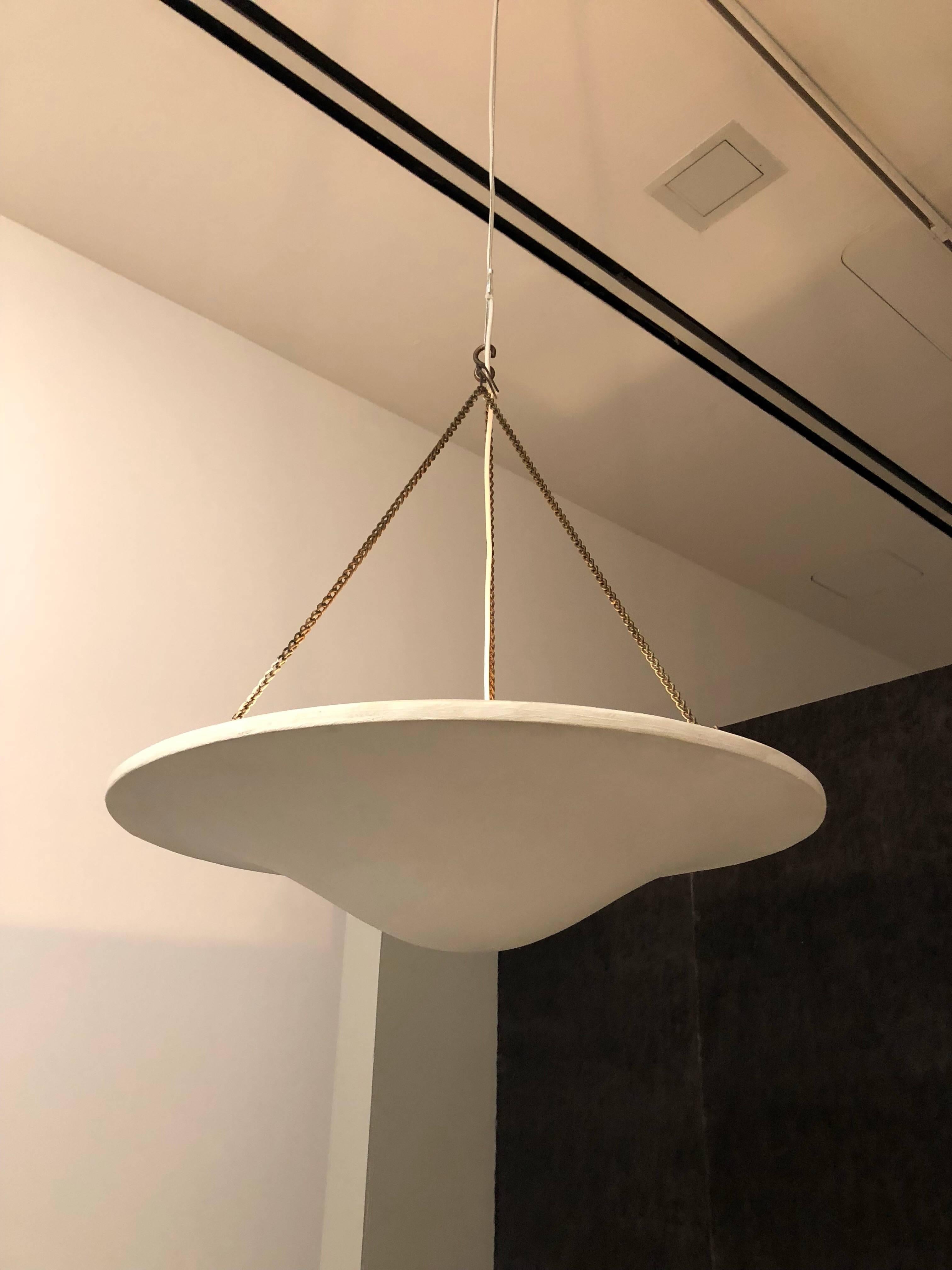 Two French Mid-Century Modern style plaster pendants / chandeliers / flush mounts, copy of a model by Alberto and Diego Giacometti for Jean Michel Frank.

Hung with brass / bronze braided chain and can be outfitted with one to four lights. Height is