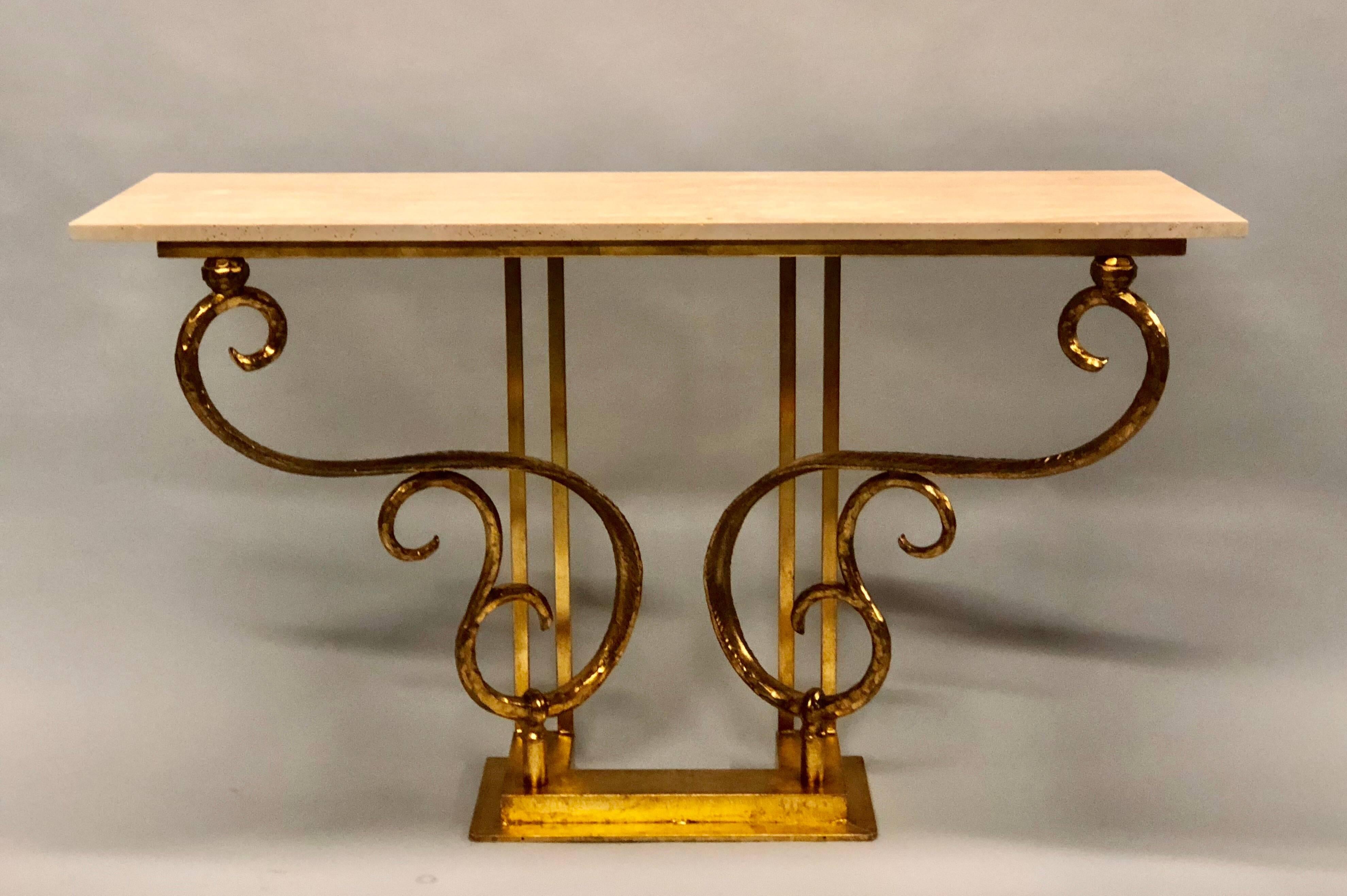 Two Italian Mid-Century Modern hand-hammered iron consoles or sofa tables by Italian sculptor and designer, Giovanni Banci. The pieces have been hand gilt and feature an undulating, organic form, floral inspired base and have Roman travertine