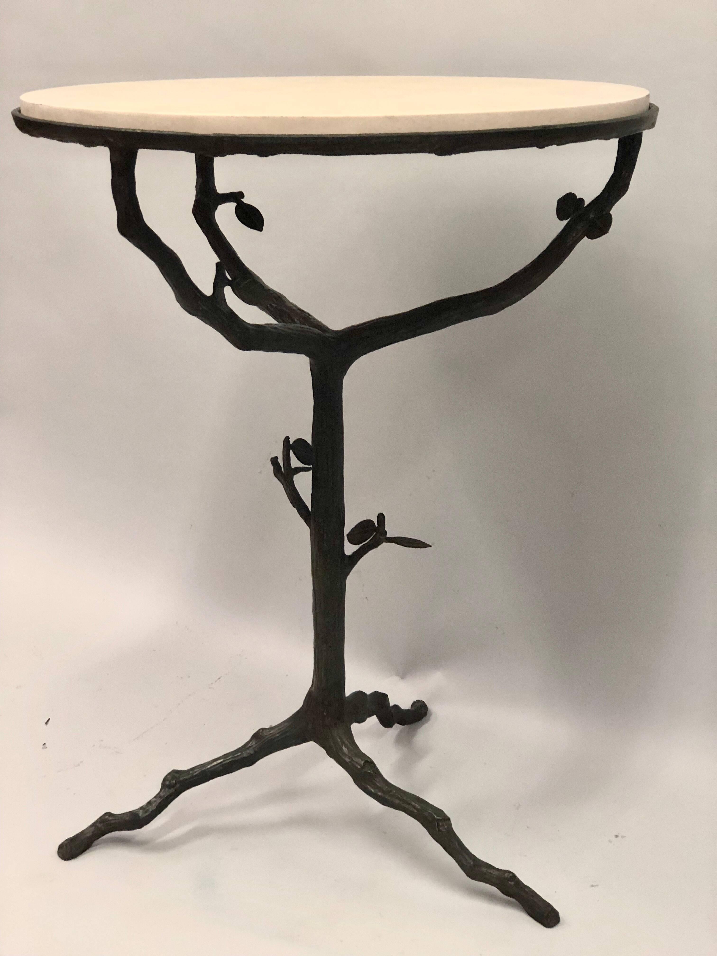 Elegant, Iconic Pair of French Mid-Century Modern side or end tables in bronze in the style of Alberto and Diego Giacometti.

The pieces feature a bronze organic form tripod base and stem with twig and leaf decoration characteristic of the