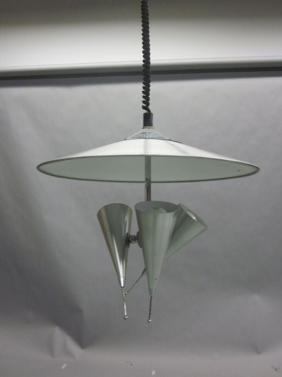 An Italian Mid-Century Modern tri-reflector chandelier / pendant / fixture in aluminum / metal with a unique sculptural presence. Each reflector is adjustable can cast light in three directions at once or as desired. 

Height is variable as it can