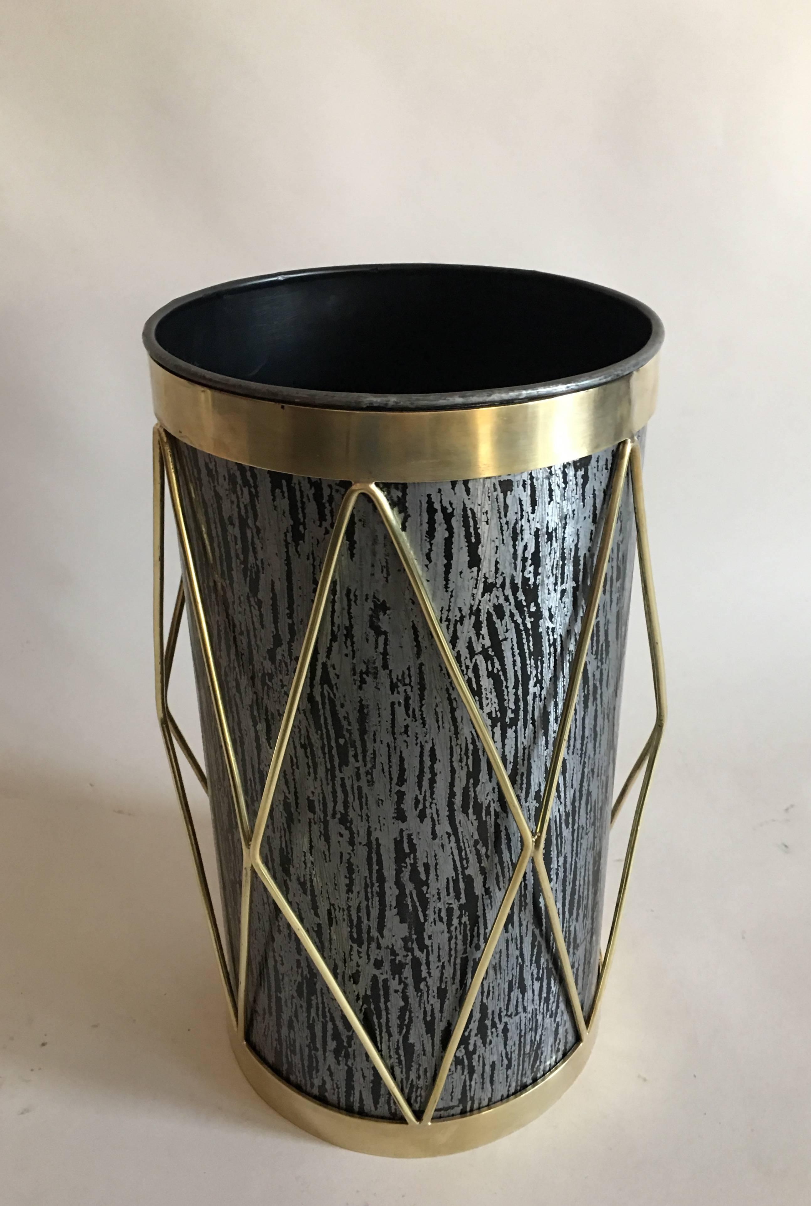 2 French Mid-Century Modern brass and steel umbrella stands, waste baskets / trash cans. 

The pieces are composed of black stippled steel, and adorned with a dramatic brass overlay in a chevron or harlequin pattern.

Priced and sold