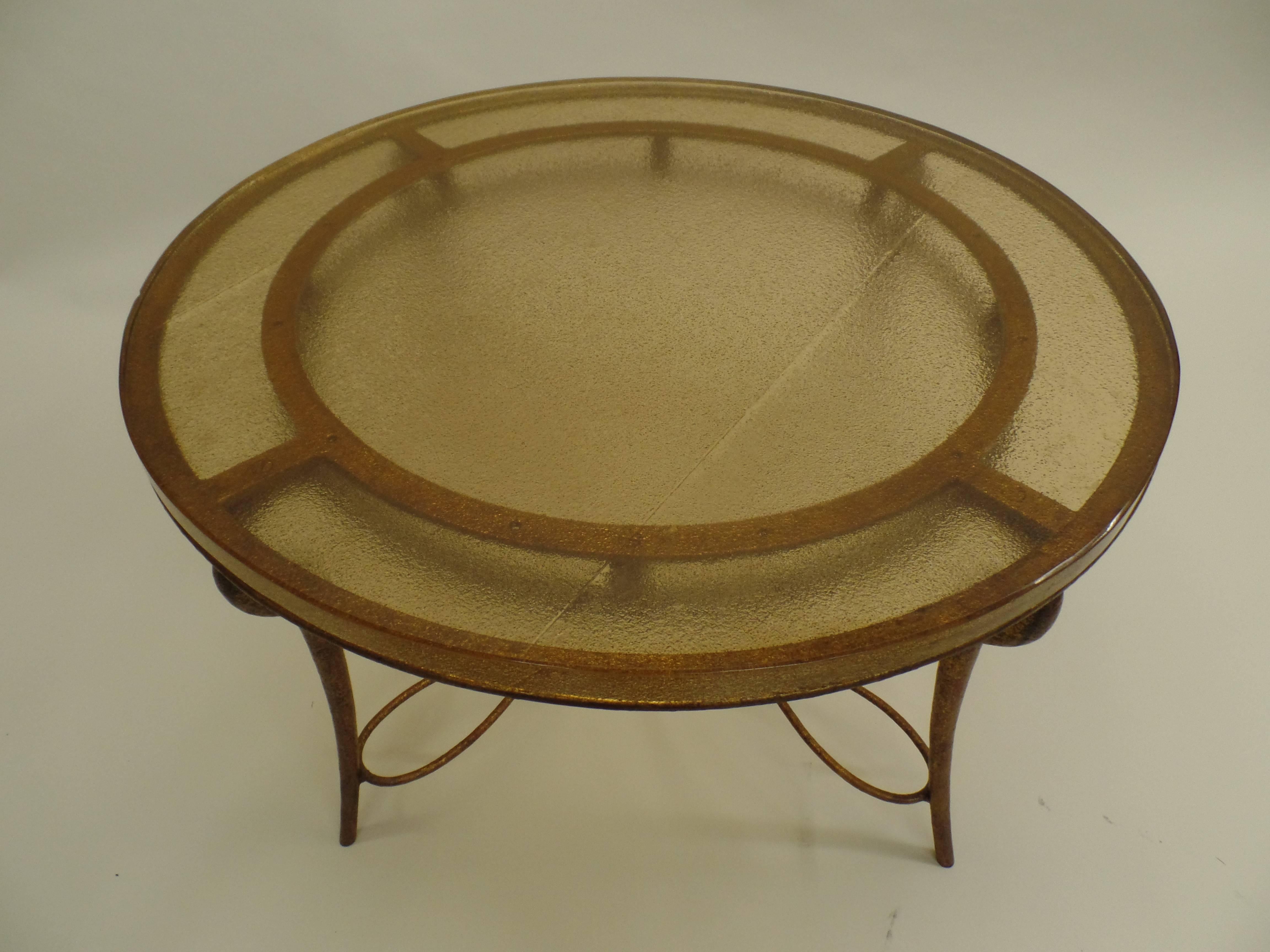 Elegant and chic coffee table in the Modern Neoclassical spirit by Rene Drouet in copper colored gilt wrought iron and a glass top in cream sand cast glass by Saint Gobain. A top French piece from the 1940s.