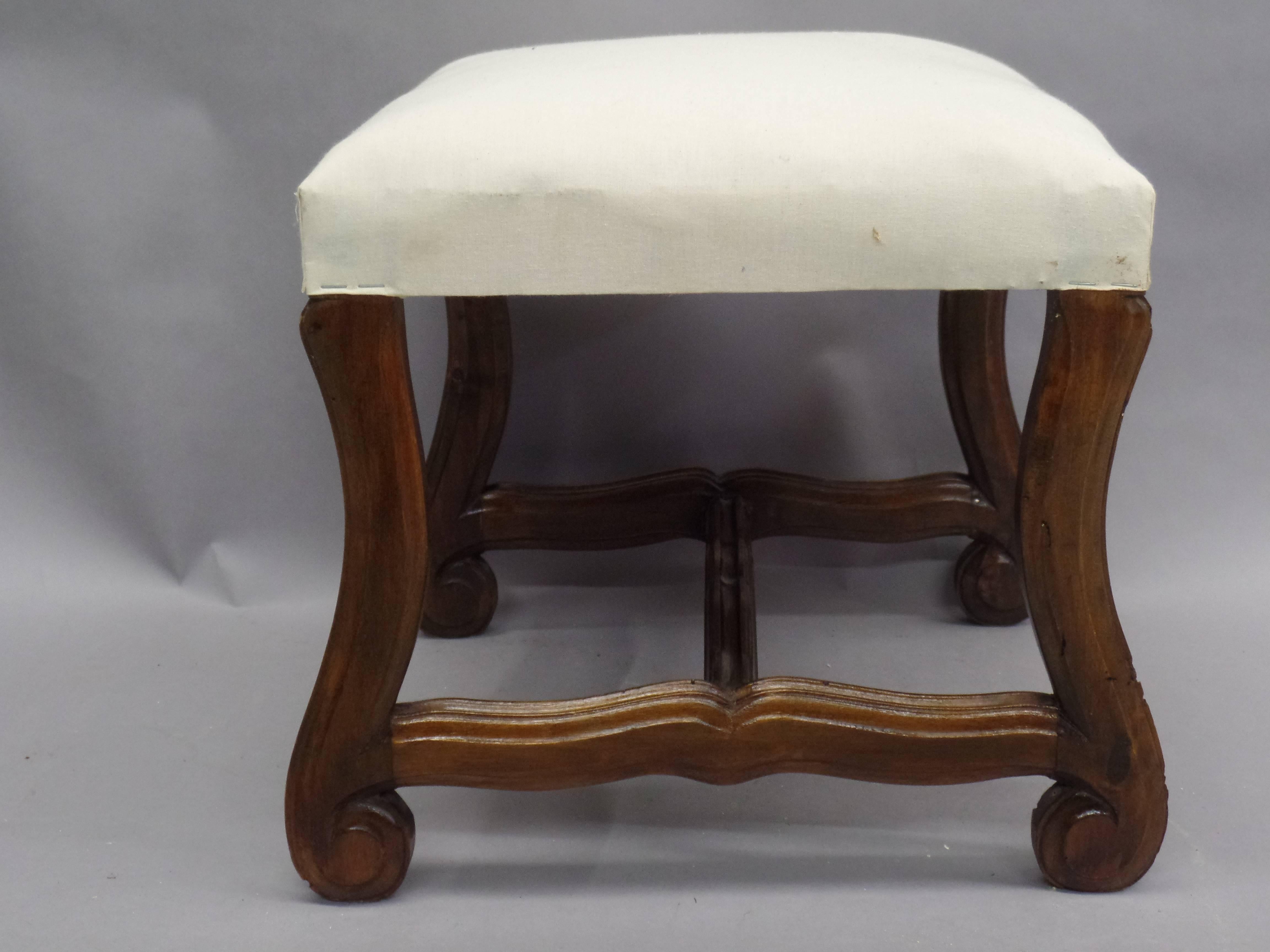 A pair of French carved stools or benches in the Style of Louis XIV, Each in walnut and delicately carved and channeled into a perfect harmony of soft curves.