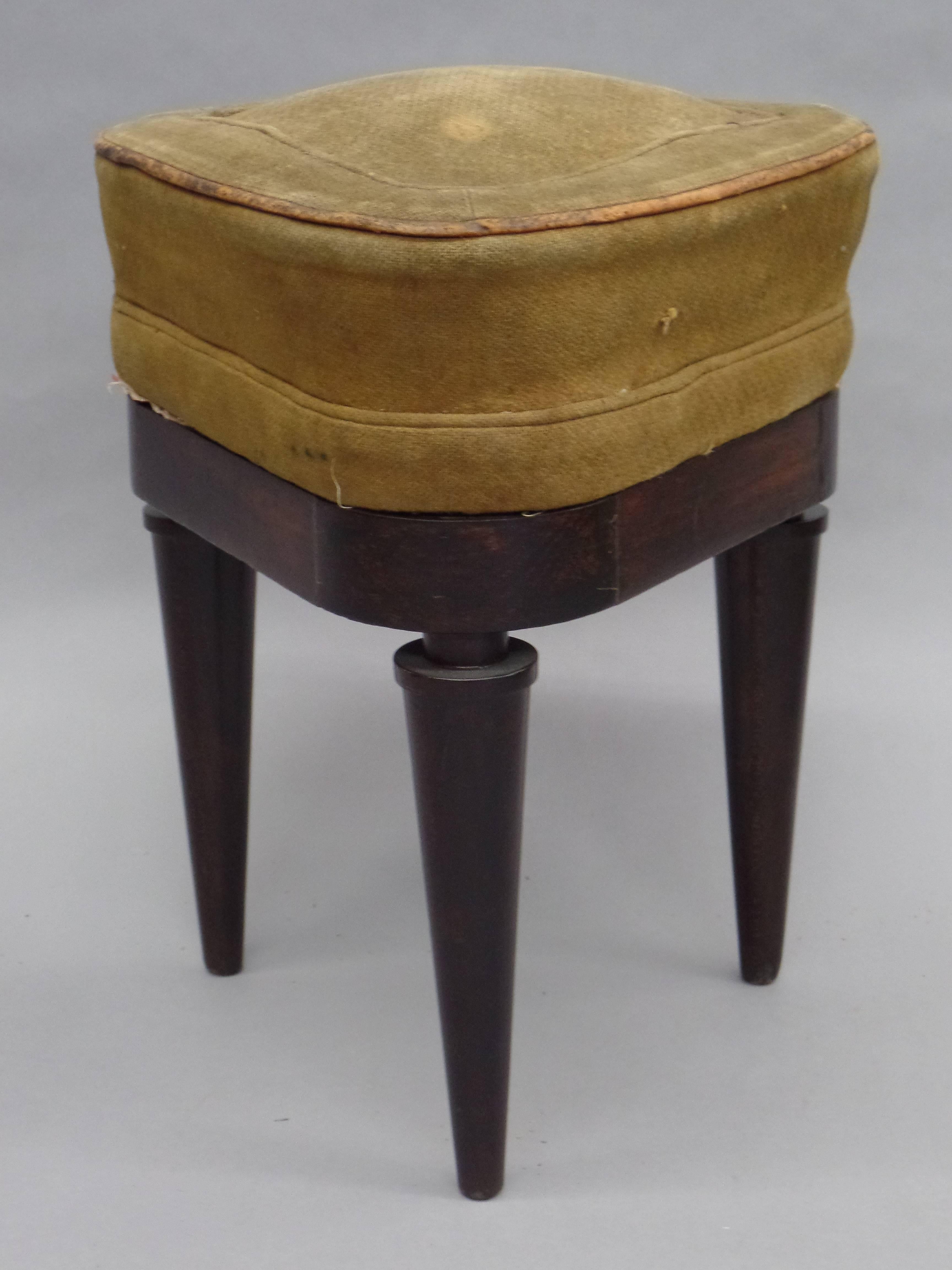 Elegant pair of french Directoire period stools / benches with stunning tapered legs that are partially cantilevered over the frame and a rare three leg and three corner structure. 

The pieces with their architectural structure demonstrate the