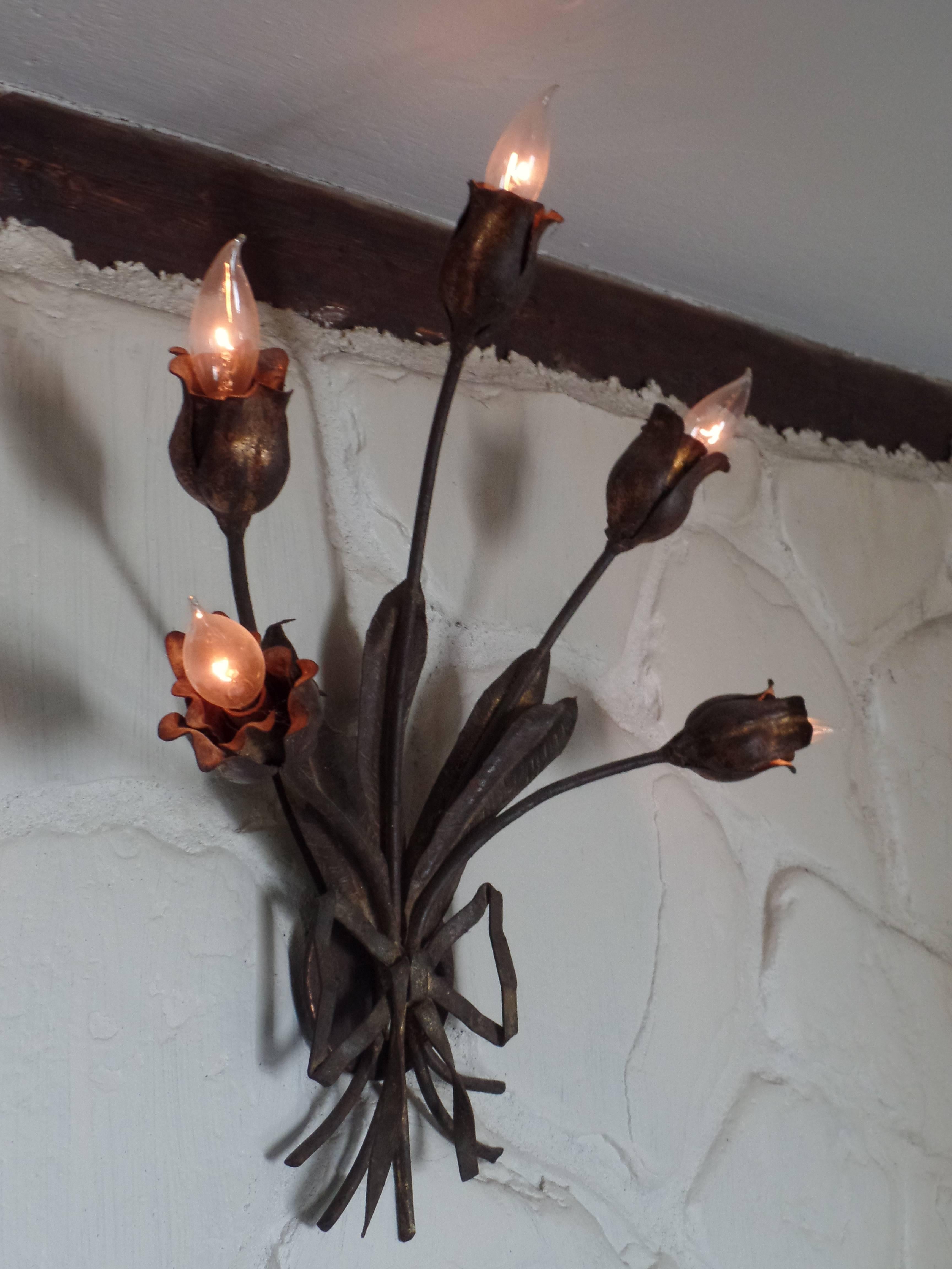 An Exquisite Pair of French Mid-Century Modern (1940 period) partially gilt wrought iron sconces attributed to Maison Bagues.

The pieces are hand-hammered and hand formed, and remarkably, the craftsmanship of the bouquet of flowers shows life