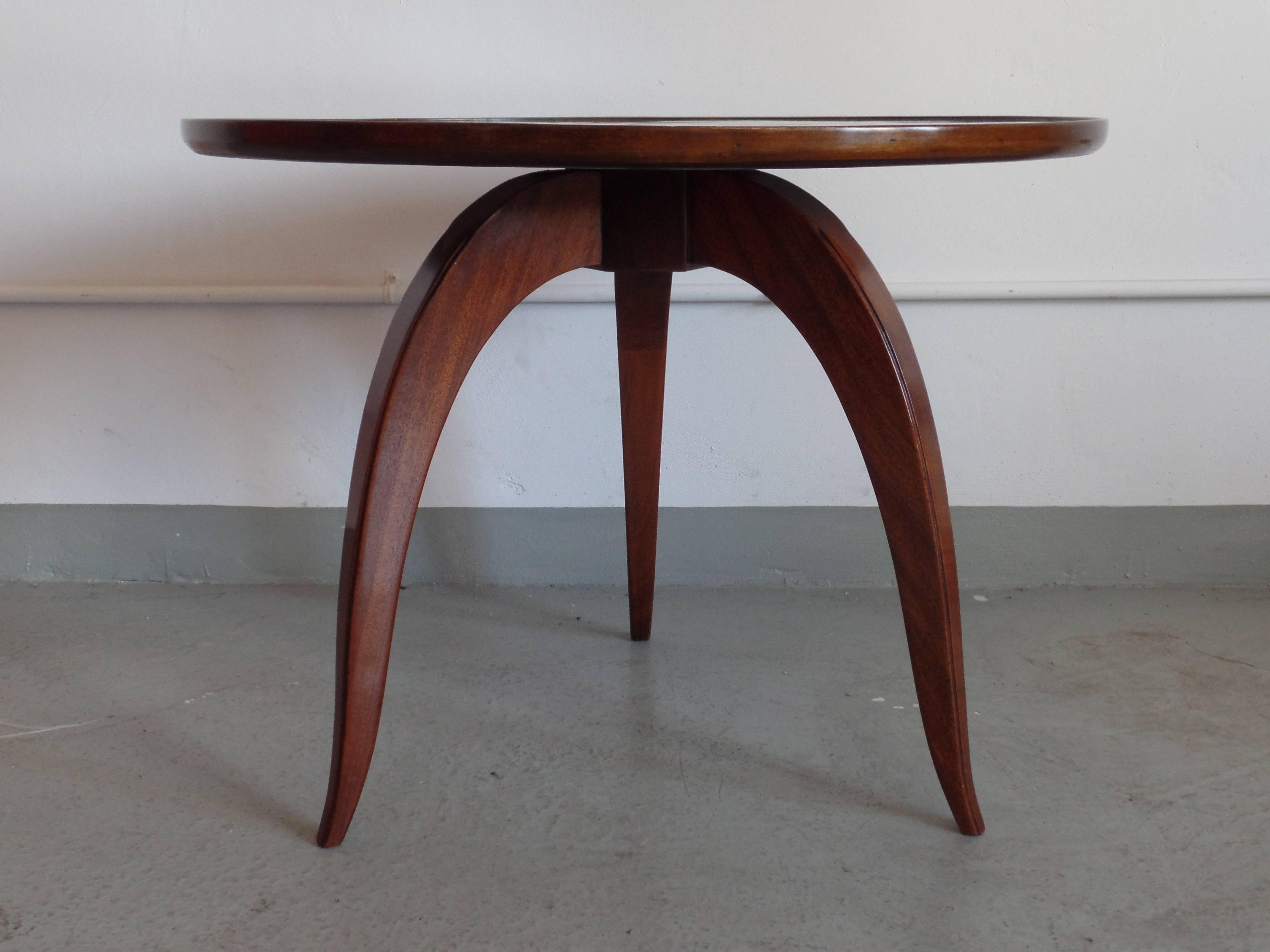 Pair of elegant French Mid-Century end tables in the modern neoclassical tradition with three tapering legs forming a tripod base supporting a refined top with a slight lip.
Tables are priced and sold individually.
   