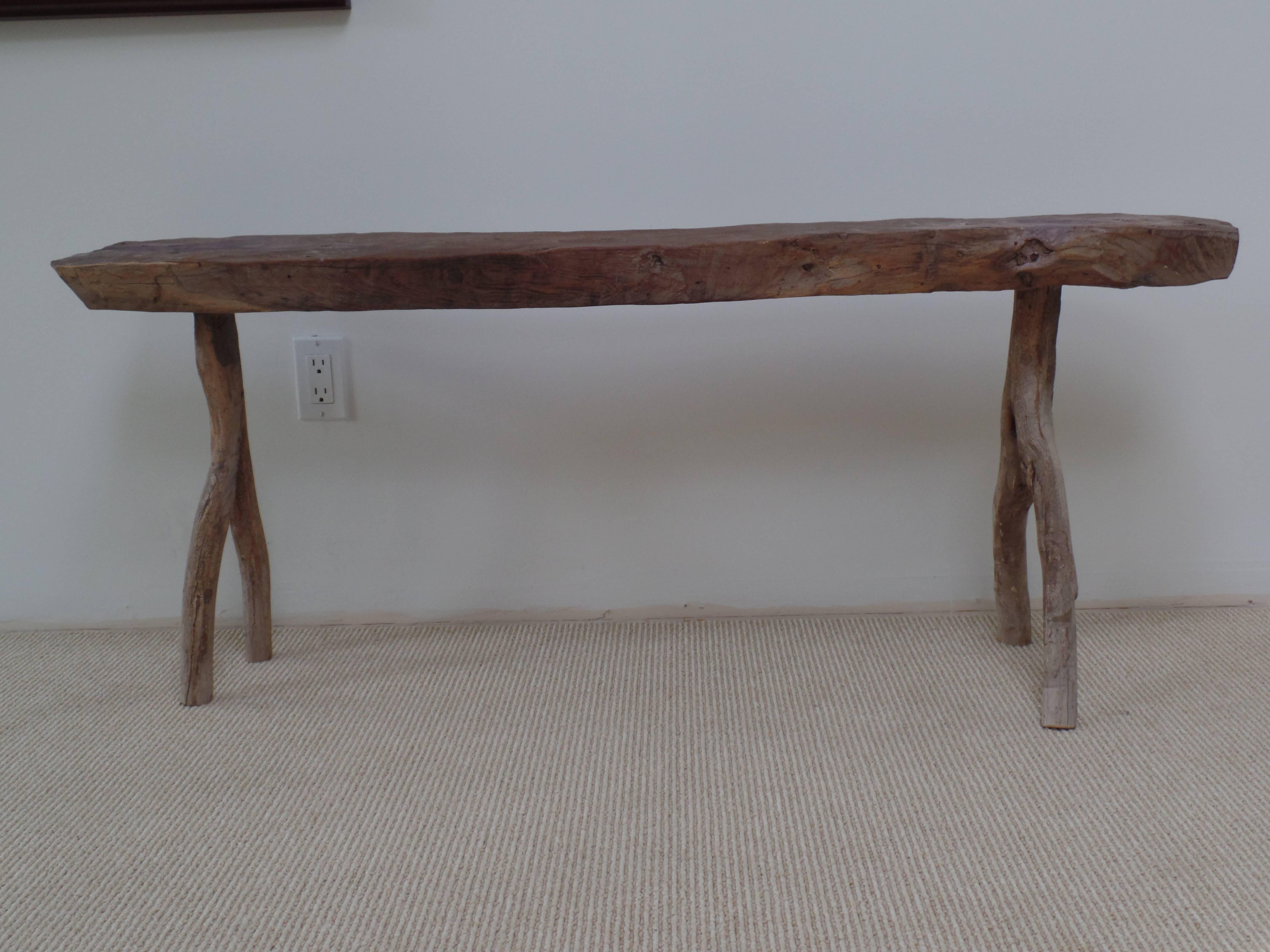 Hand-carved French Brutalist bench or settee. A comfortable, yet narrow profile bench set upon opposing legs that proudly displays it's Primitive rough hewn character. Comfortable and sculptural. 

Seat is W 51