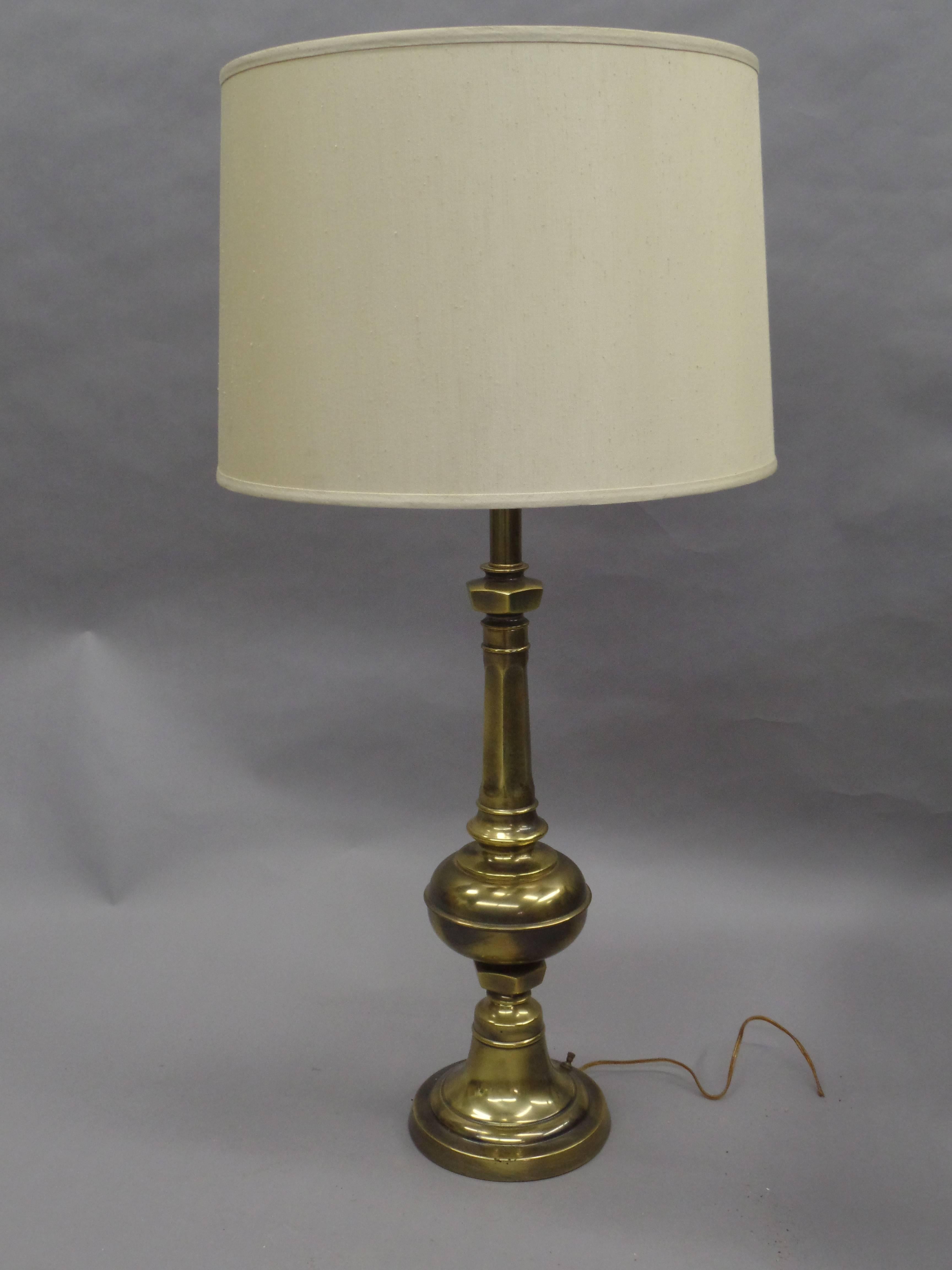 Elegant pair of solid brass English table lamps in a baluster form.

Height with shade is 38