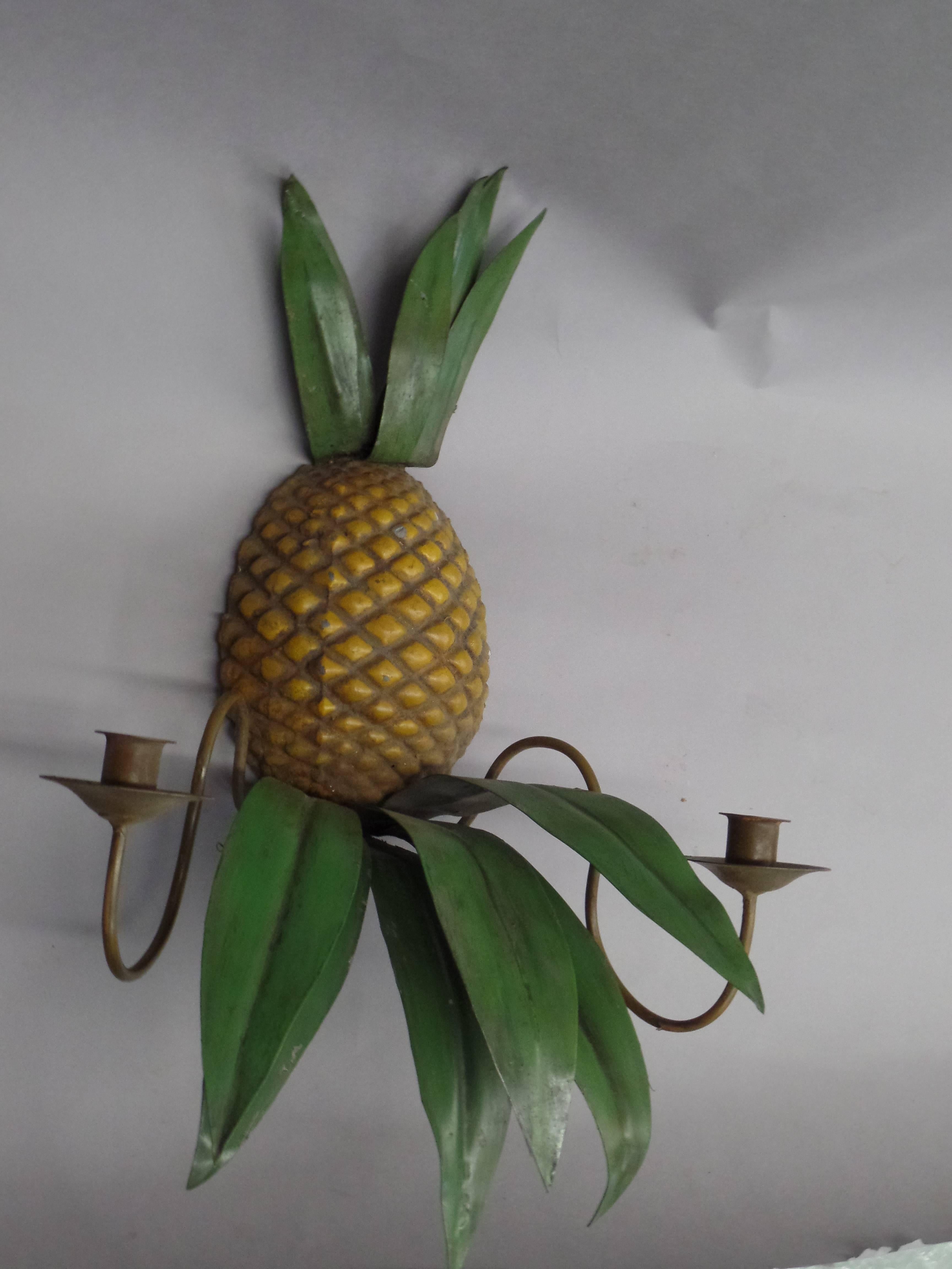 Pair of French Mid-Century Modern handmade and hand-painted toll (Tin) wall lights in the form of pineapples: traditionally a symbol of well being and welcoming. The sconces have double arms. Each can be wired to accommodate two candelabra sockets.