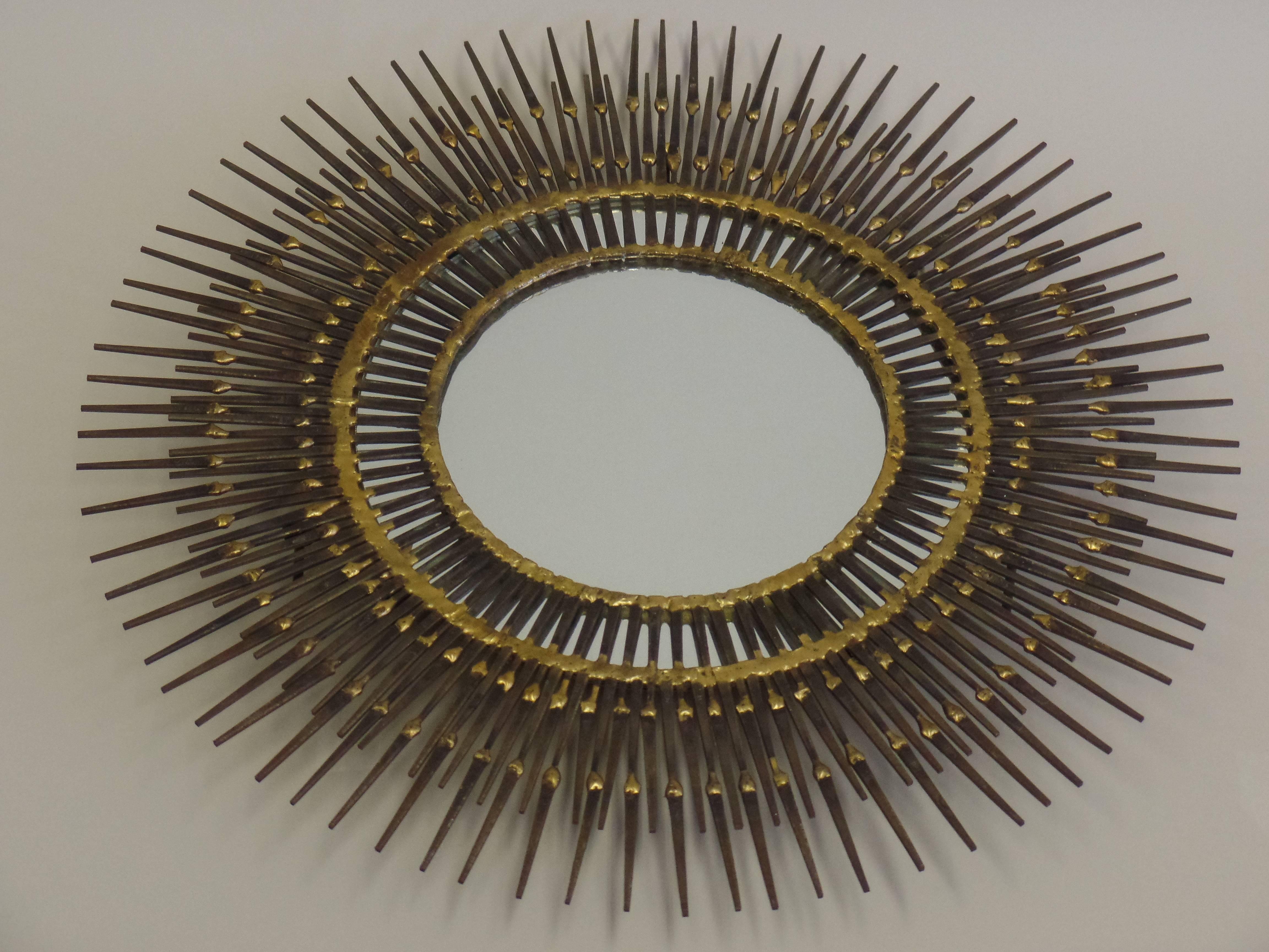 Sculptural wall mirror by the Canadian art, Bela in the form of sunburst.

A delicate Mid-Century work of art composed of multiple levels of steel nails soldered together in solid brass using open tracery to reveal a mirror underneath a ring of