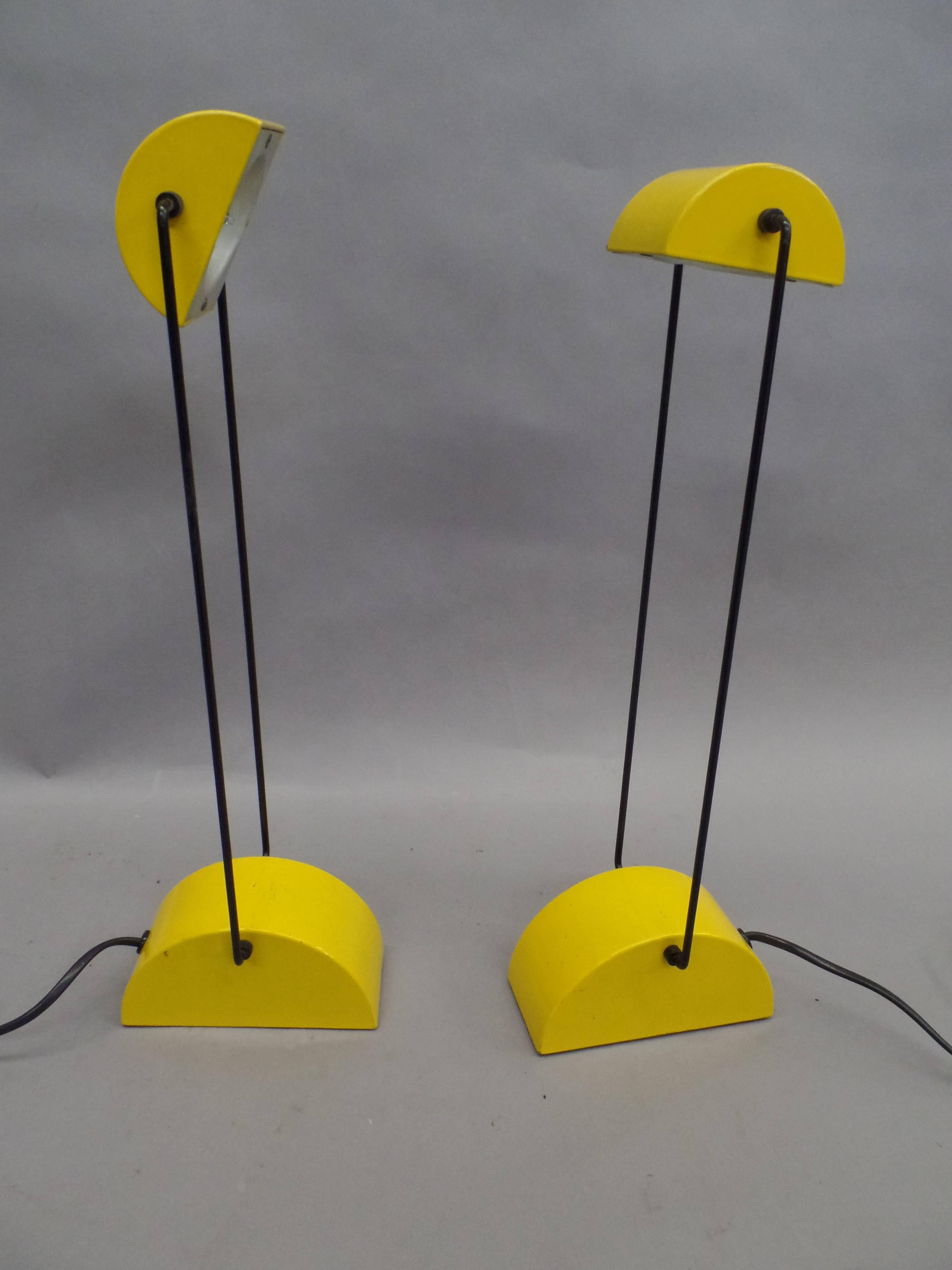 Dramatic pair of Italian table lamps by Bilumen showing the influences of Mid-Century Modern, Minimalist, Spage Age and memphis design. 

Simple, beautiful forms with a dramatic color contrast in yellow and black enameled metal and with pivoting,