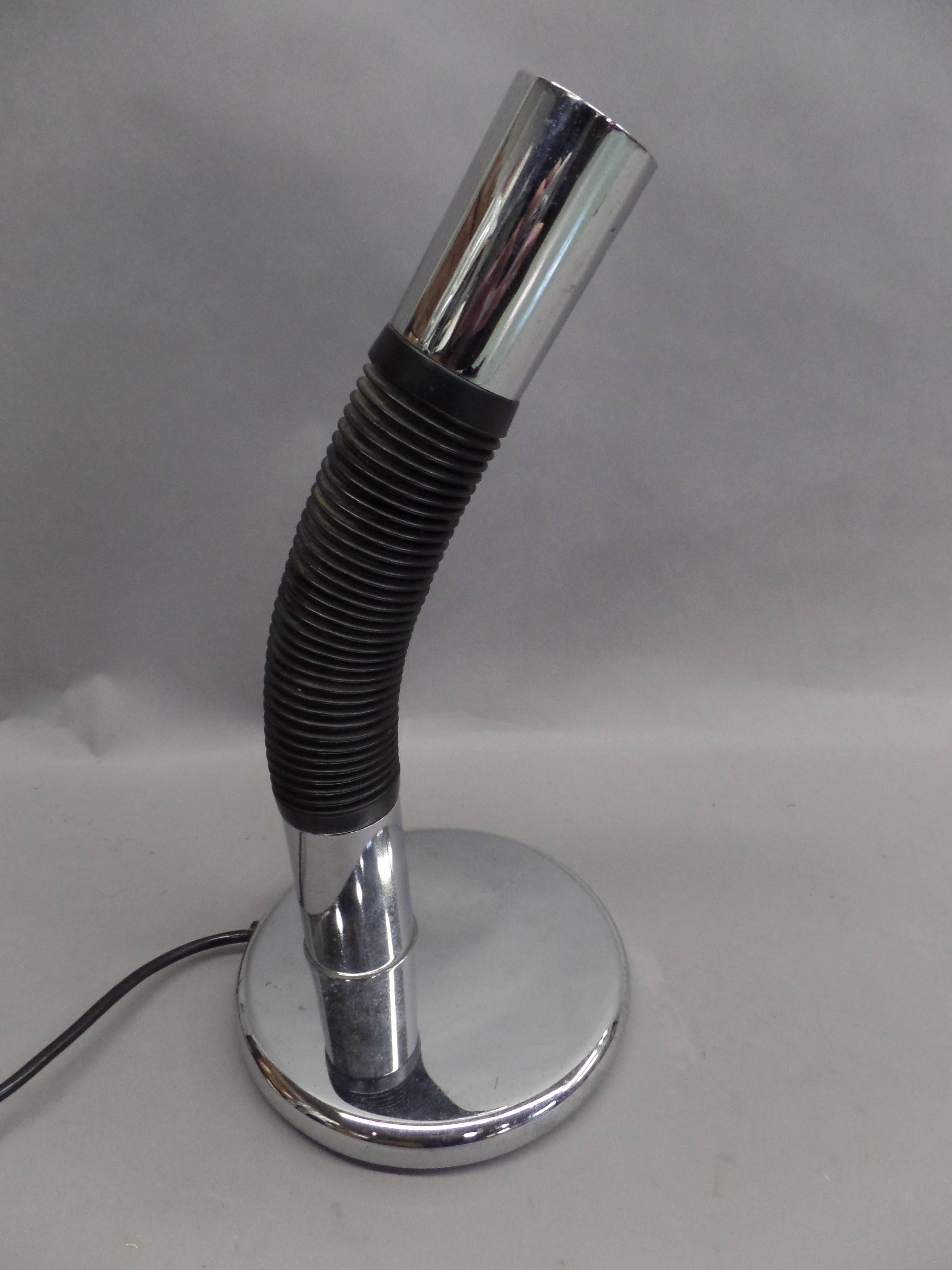 Rare Italian Mid-Century Modern (Space Age) table lamp in chromed metal and flex-rubber-plastic that adjusts to send light down, sideways or up. 

Labelled: Targetti Sankey on frame.