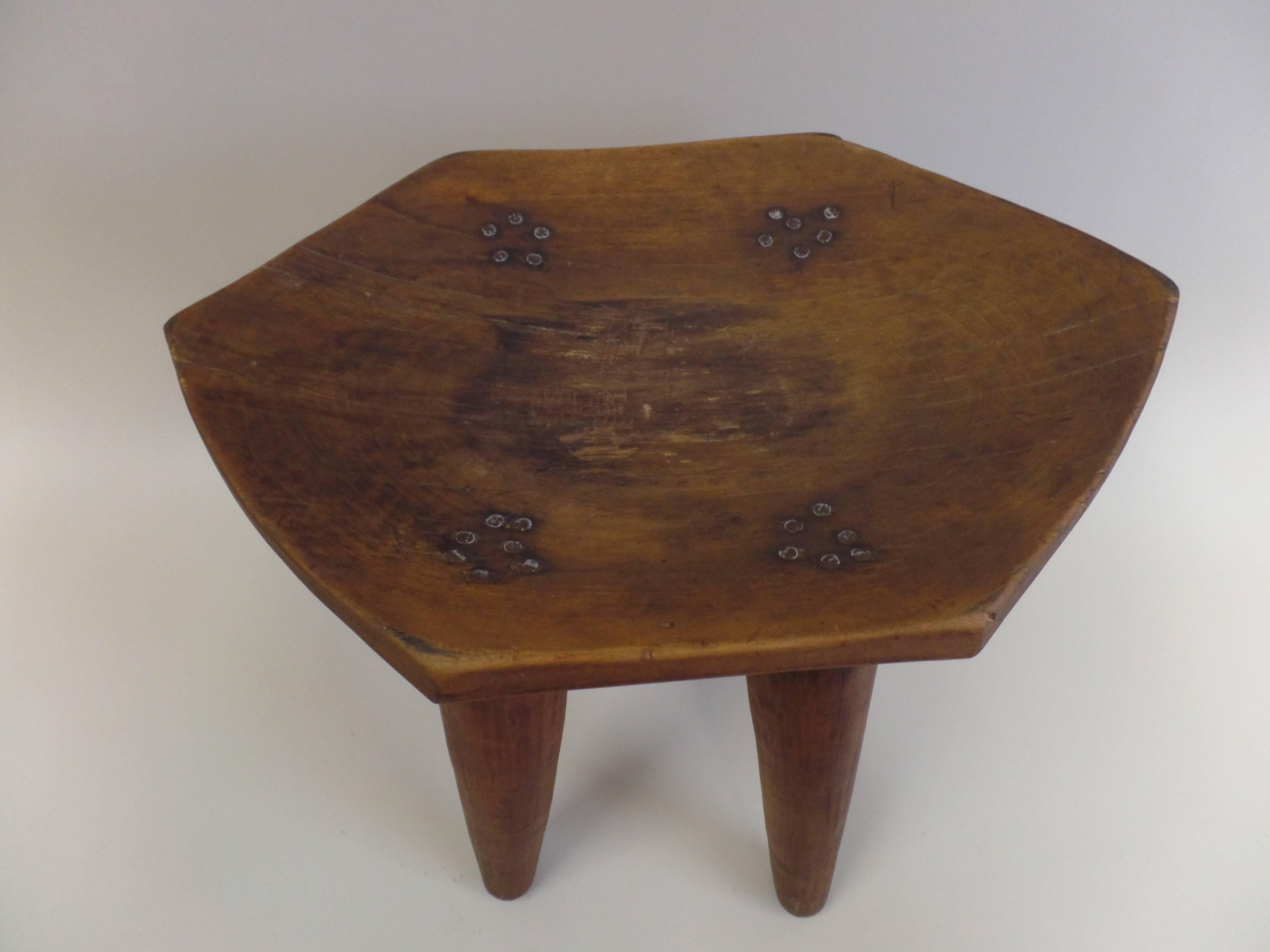 A hand-carved French stool or bench with the six-sided seat 'scooped out' the piece reflects an interest during the Art-Deco and Post Art Deco periods (1920-1930s) in a sober, modern presentation along with interest in the naturalism non-Western