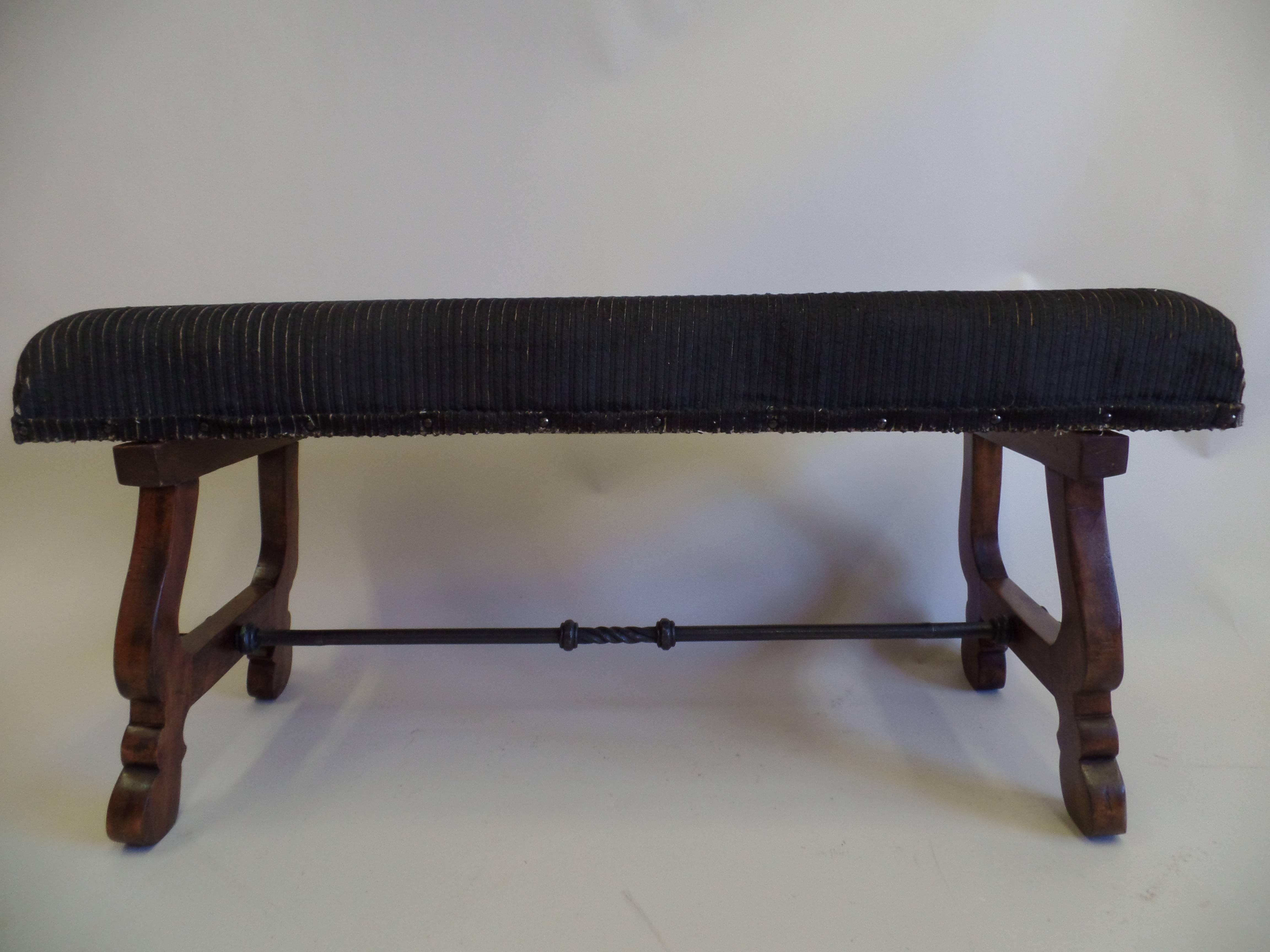 Handmade Italian Mid-Century bench in walnut with legs in the form of Lyre with a hand-wrought and hammered iron stretcher. 

The bench has an effective contrast materials (walnut vs.iron) and preserves a distinct sober, modern neoclassical