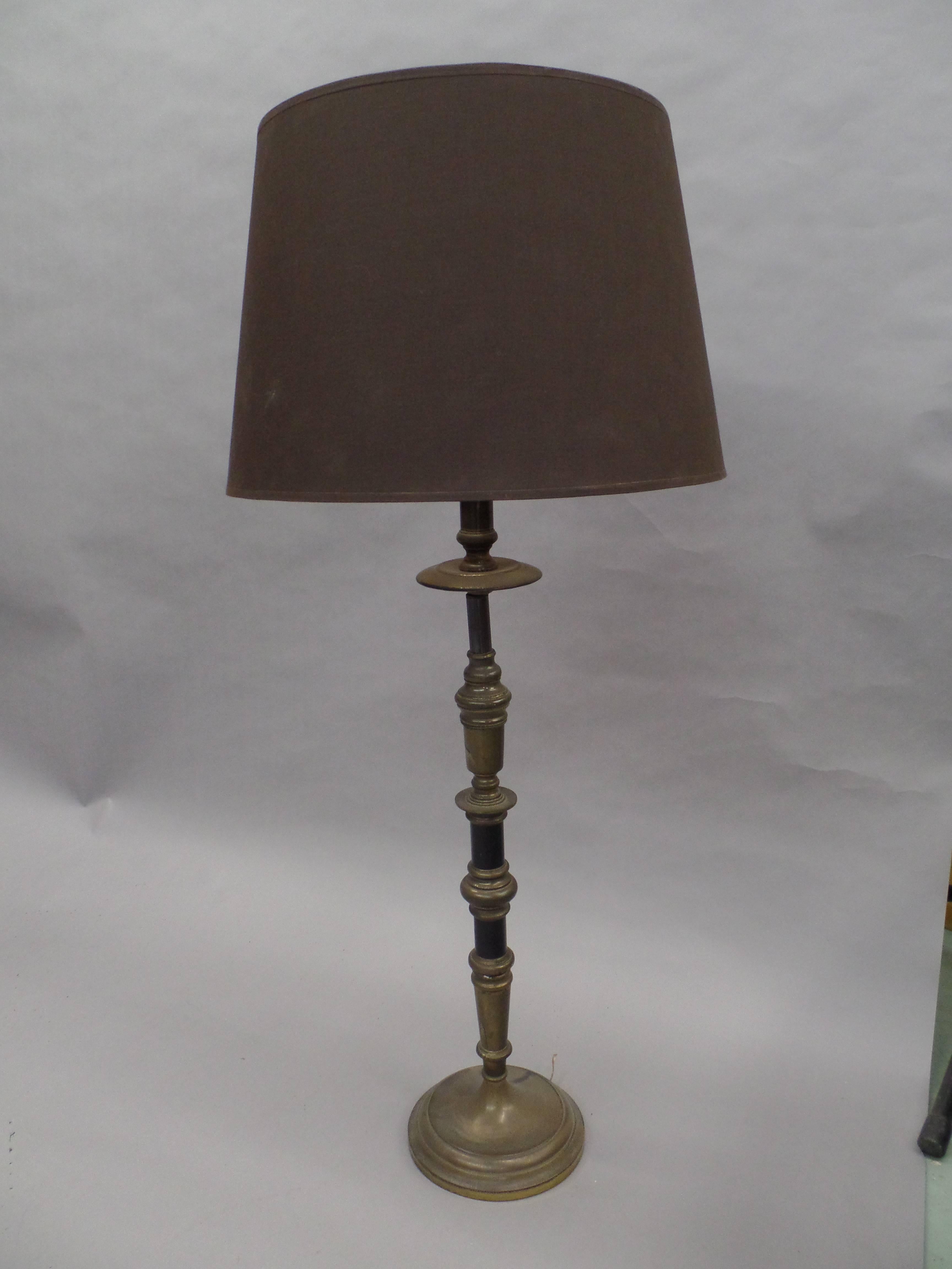 Pair of elegant and refined French Classic candlestick formed table lamps in silvered brass and black enamel.

Shades are for demonstration purposes only.