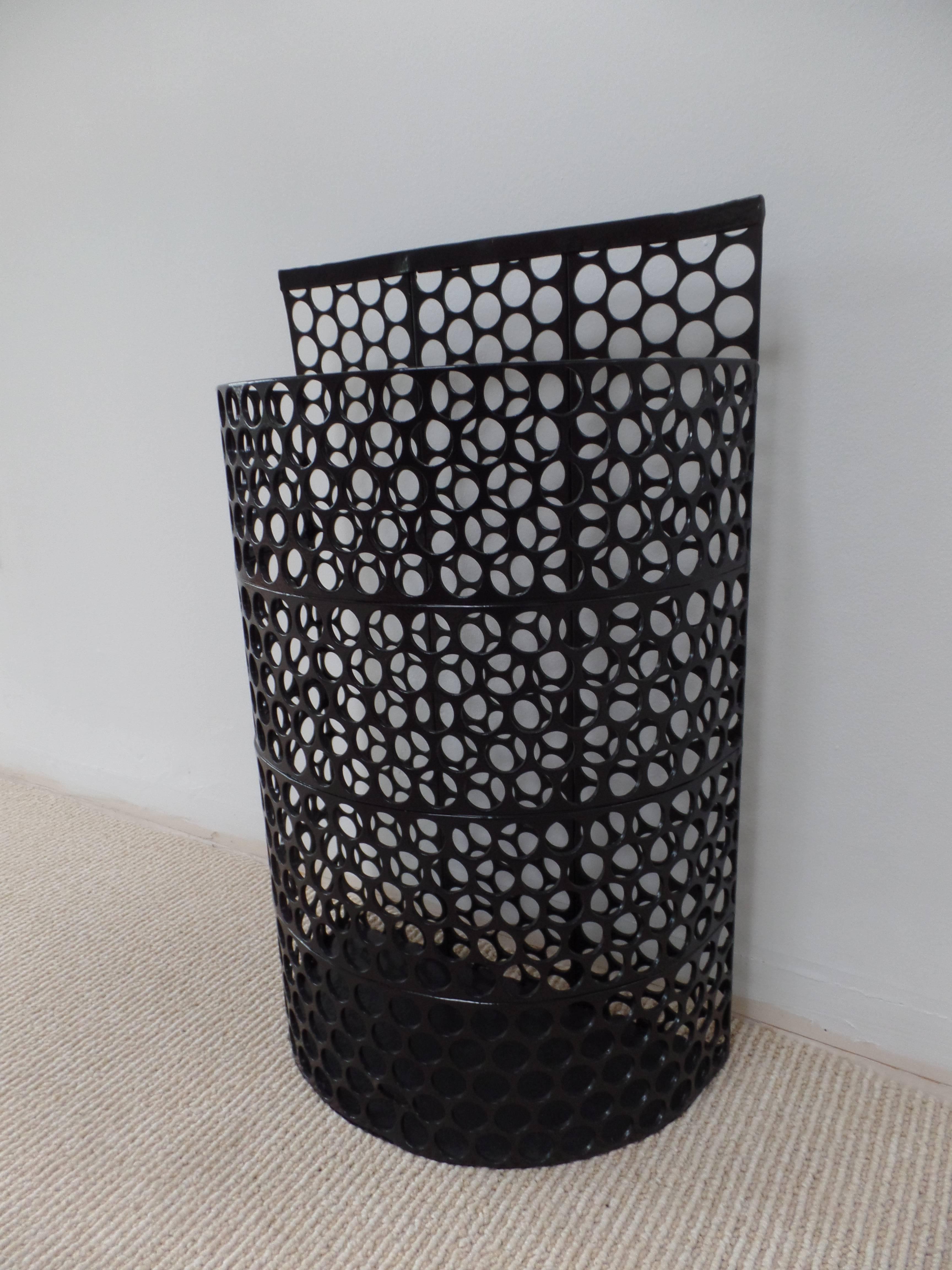 French Mid-Century Modern umbrella stand or trash/ wastebasket composed of black enameled perforated metal in the Industrial style of Jean Prouve and Mathieu Matégot.

