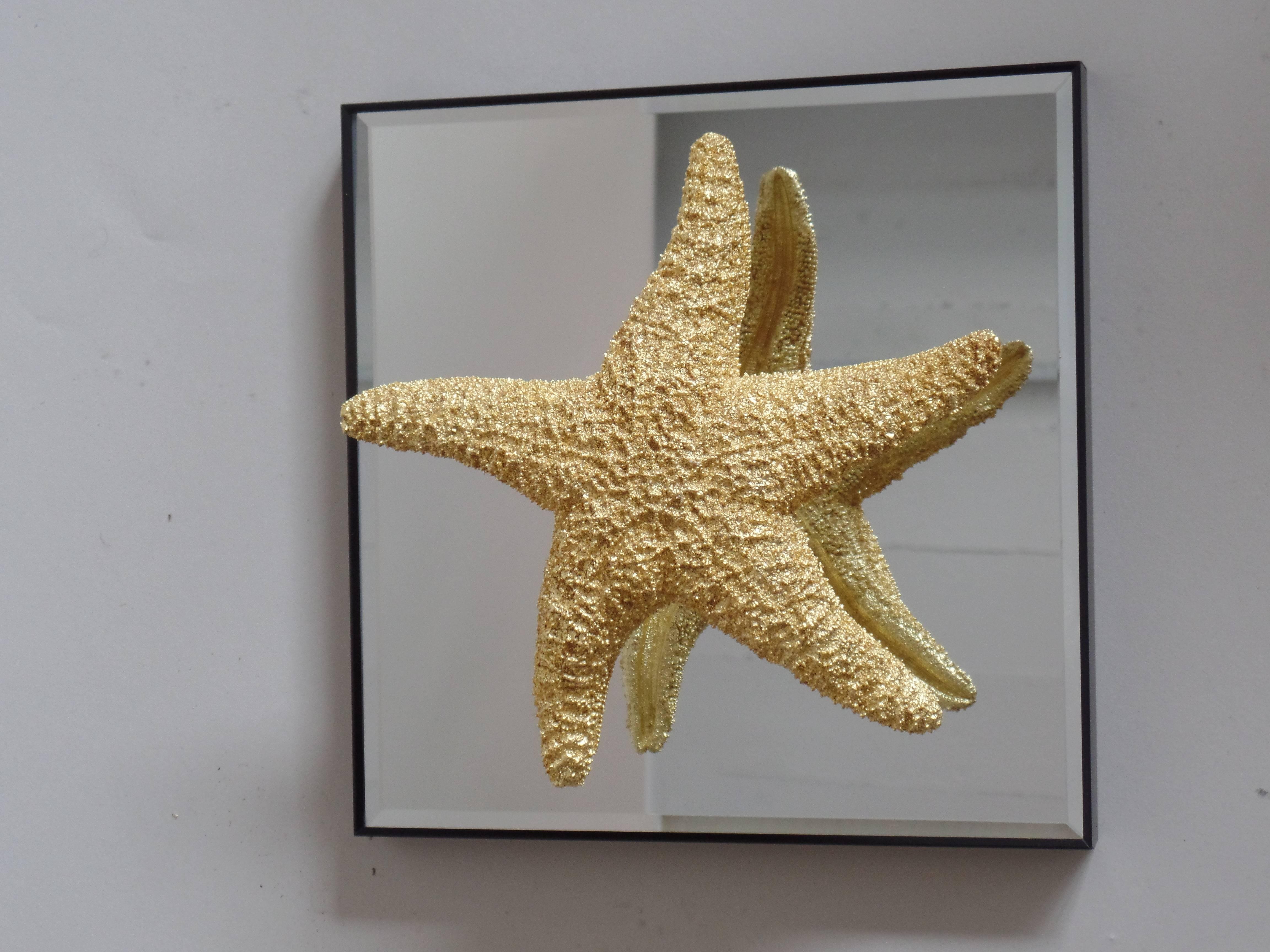 Stunnng mirrors with applied, suspended starfish, each gilt in 23-carat gold with inspiration from French Surrealist Designers, Jean-Charles Moreux and Bolette Natanson. Each starfish is natural and slightly different from each other. They rest
