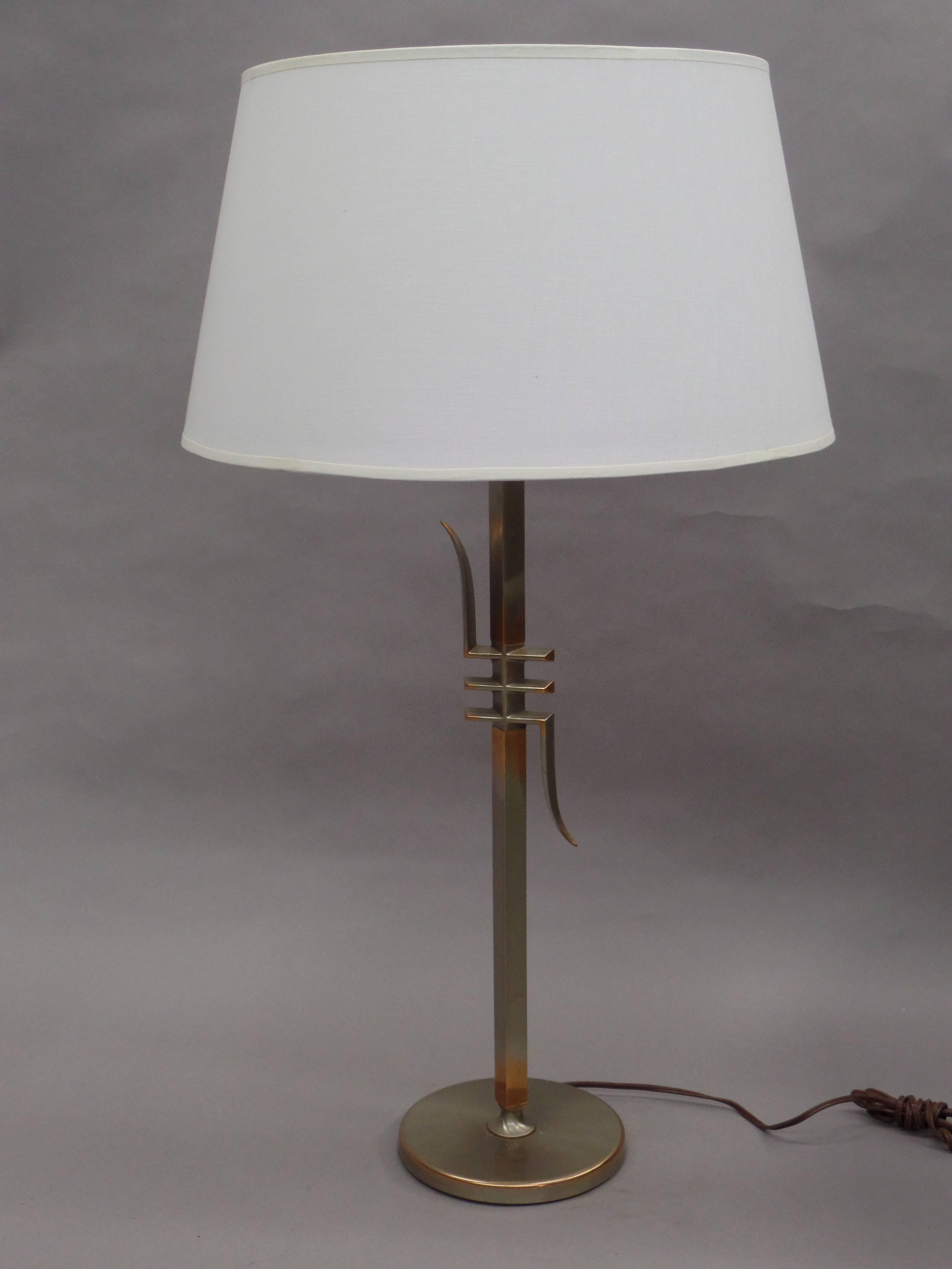 Elegant pair of American Mid-Century Modern table lamps typical of James Mont that reference exotic Asian calligraphic forms yet are modern in their aesthetics. The nickel is worn in several locations revealing the warm copper underneath. 

Height