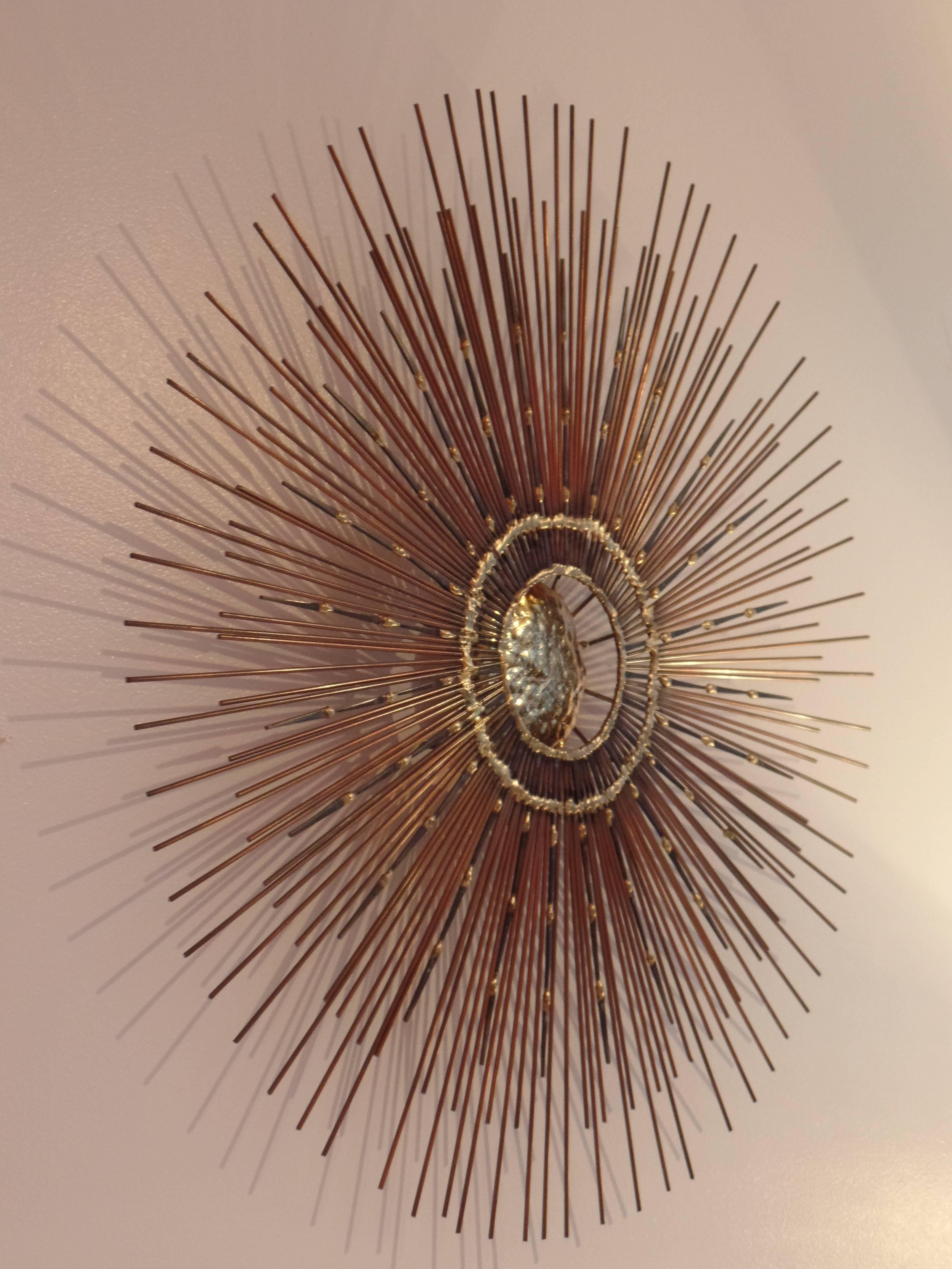 Elegant Mid-Century wall mirror in modern neoclassical spirit by French Canadian artist, BELA. 

The wall mounted sculpture/mirror features a stunning structure composed of a rare combination of polished brass and alternating steel and copper rods.