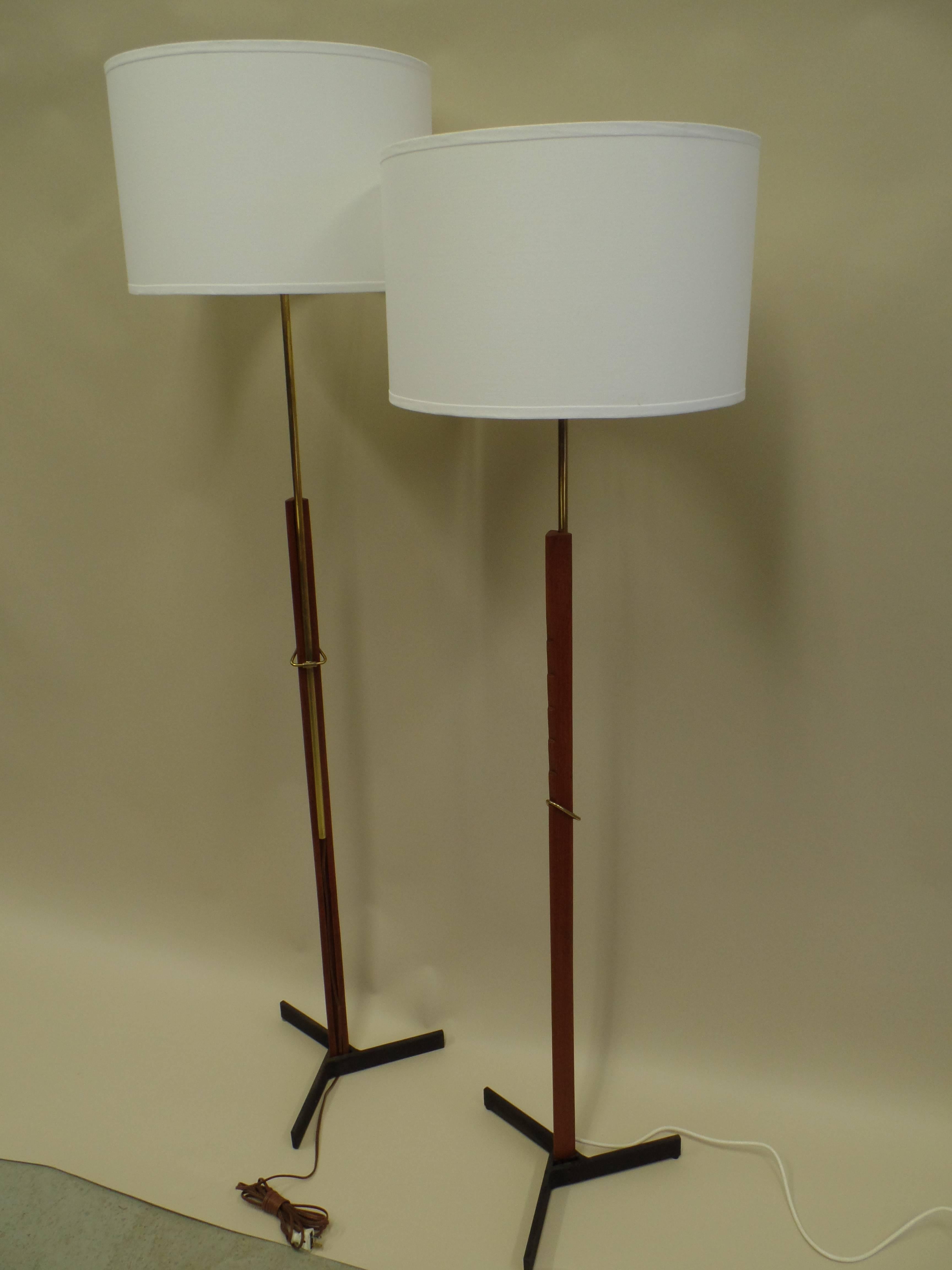 A rare and exquisite pair of Scandinavian Modern standing lamps by Svend Aage Holm Sorensen conveying the beauty and functional efficiency of Scandinavian design. These pieces are engineered with a unique adjustable stem system and designed with a