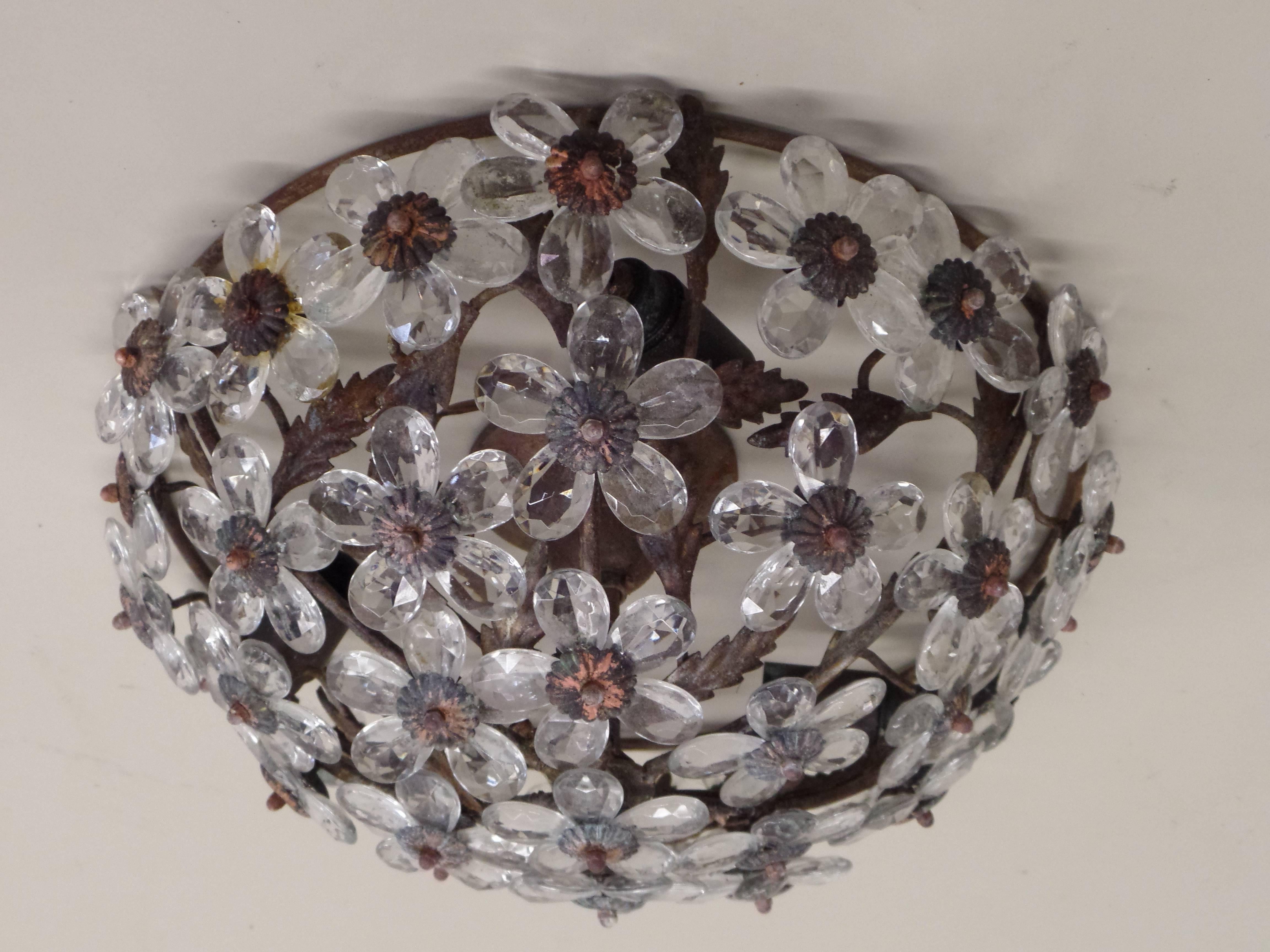 An Italian crystal floral flush mount fixture. The floral petal are composed of crystal and set into antique iron frame. 

This piece can also be mounted as a pendant via a stem.