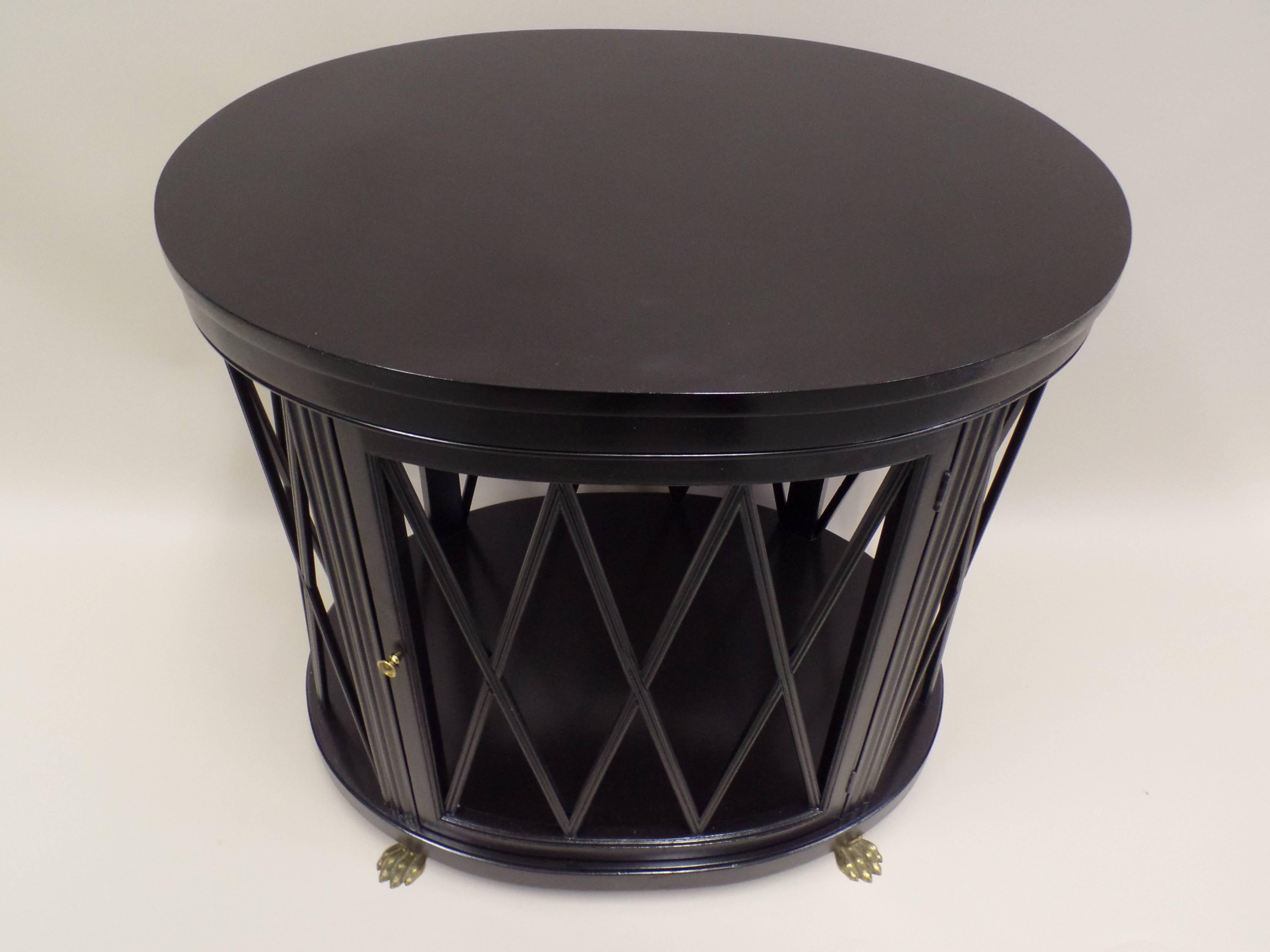 Elegant pair of oval form French Mid-Century Modern Neoclassical Ebonized Wood end tables / sofa tables by Maison Jansen. 

The tables feature a stunning X-frame design around the circumference which allows transparent viewing completely through the
