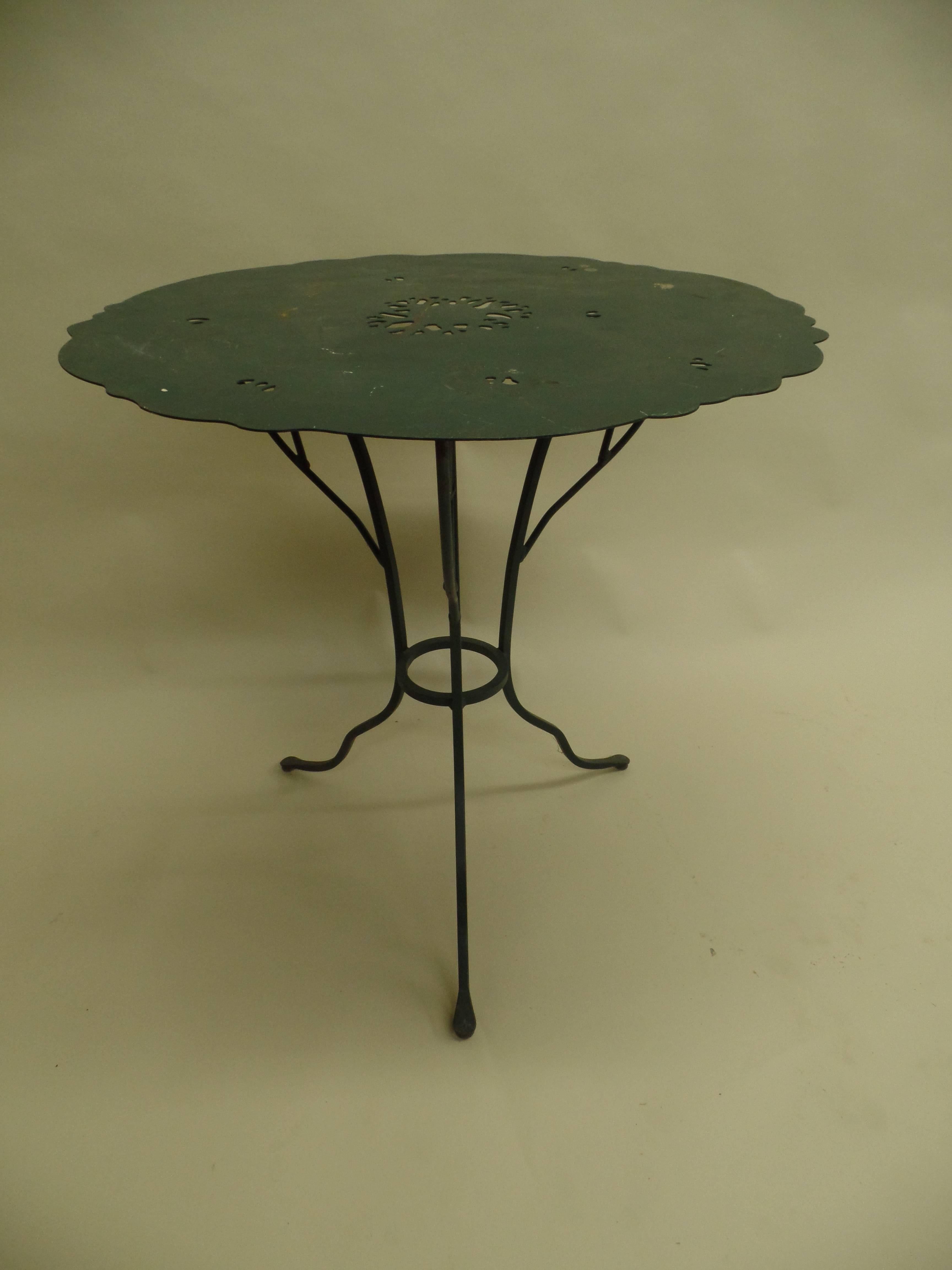 A unique pair of French Mid-Century end tables / gueridons, cafe tables in hand-wrought iron for use indoors or outdoors. The tables show the influence of Alberto and Diego Giacometti with the iron bases being hand-wrought in the form of a branching