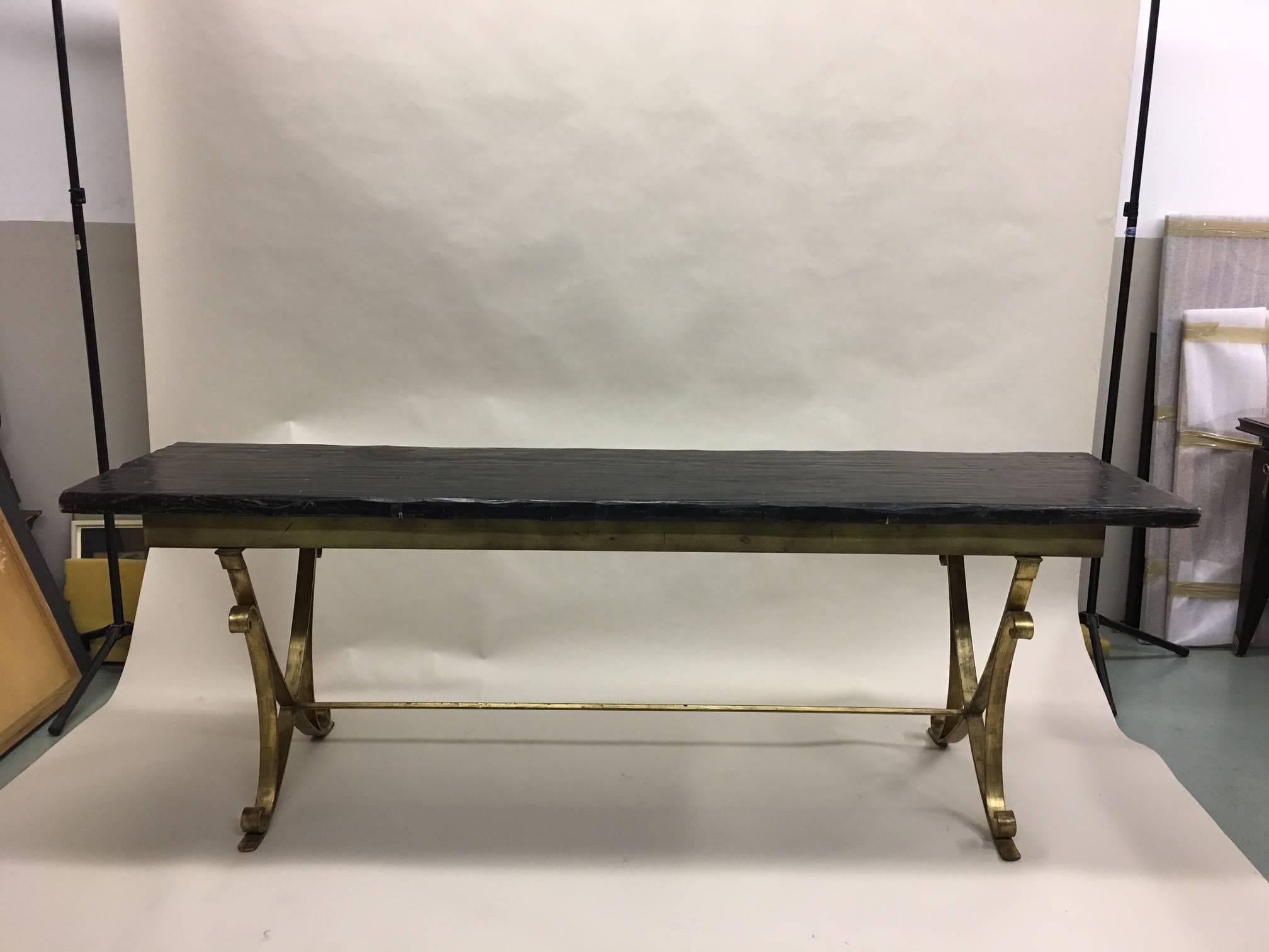 Elegant French handwrought iron dining table attributed to Raymond Subes in the modern neoclassical spiritt with each of the two base structures in an X-form / curile design. 

Base dimensions alone are: H 28.5 x W 75 x D 22. Dimensions below are