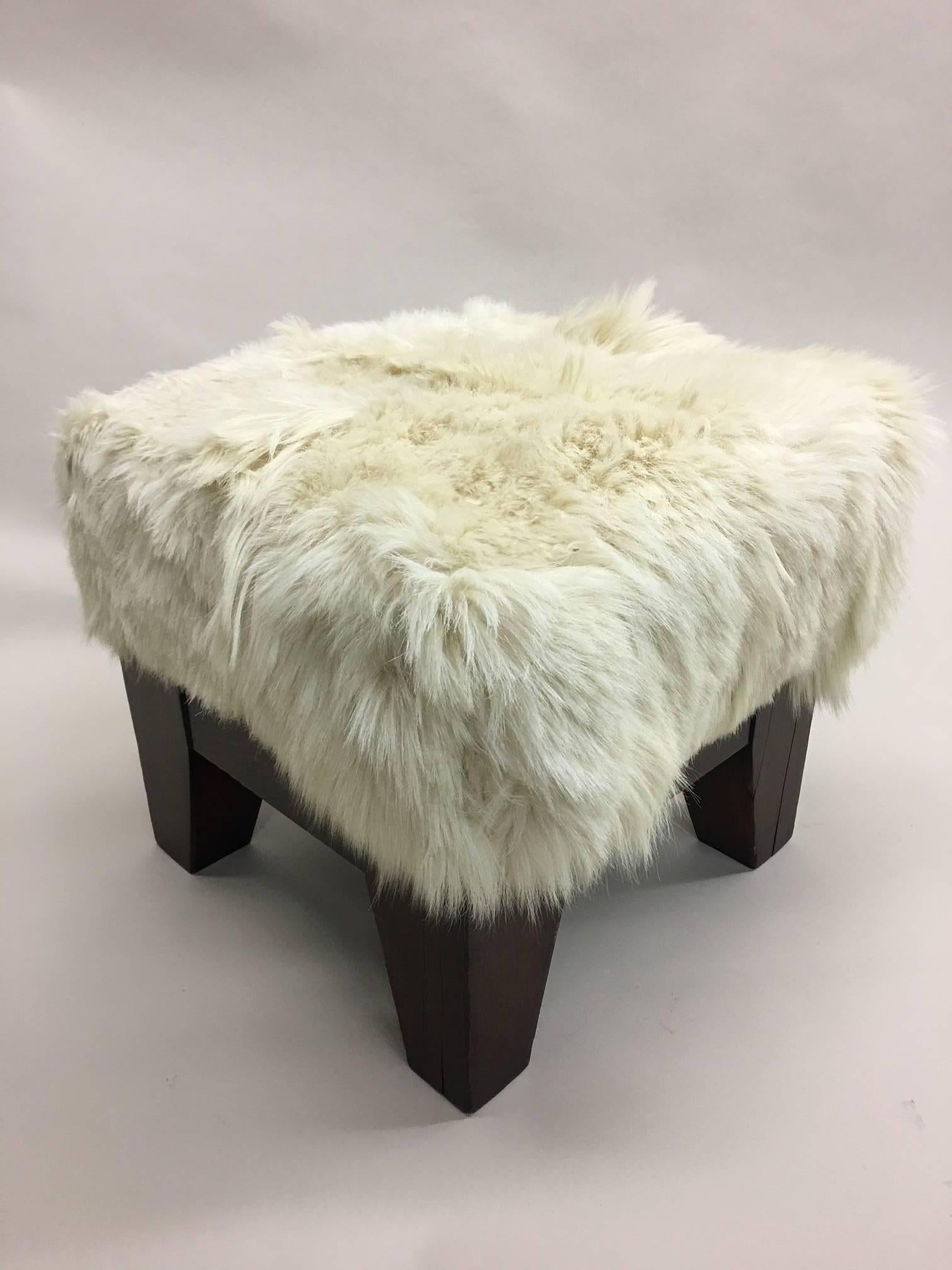 Elegant pair of Italian Mid-Century Modern stools / benches with tapered legs and covered in sheep skin. 

 