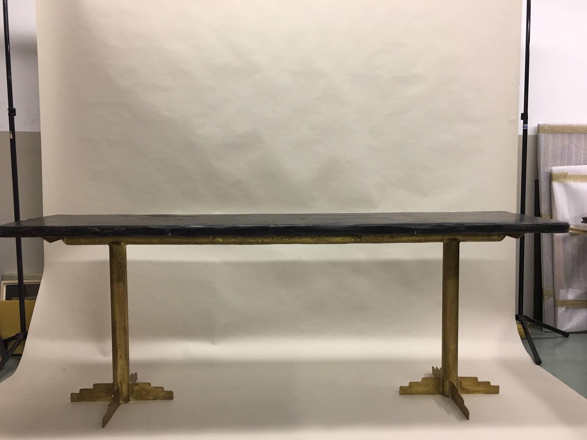 Two large French Mid-Century Modern / Art Deco Gilt iron tables in the tradition of France's great iron workers: Paul Kiss, Edgar Brandt, Raymond Subes and Gilbert Poillerat. 

Each base is composed of two legs with each leg supported by stepped and
