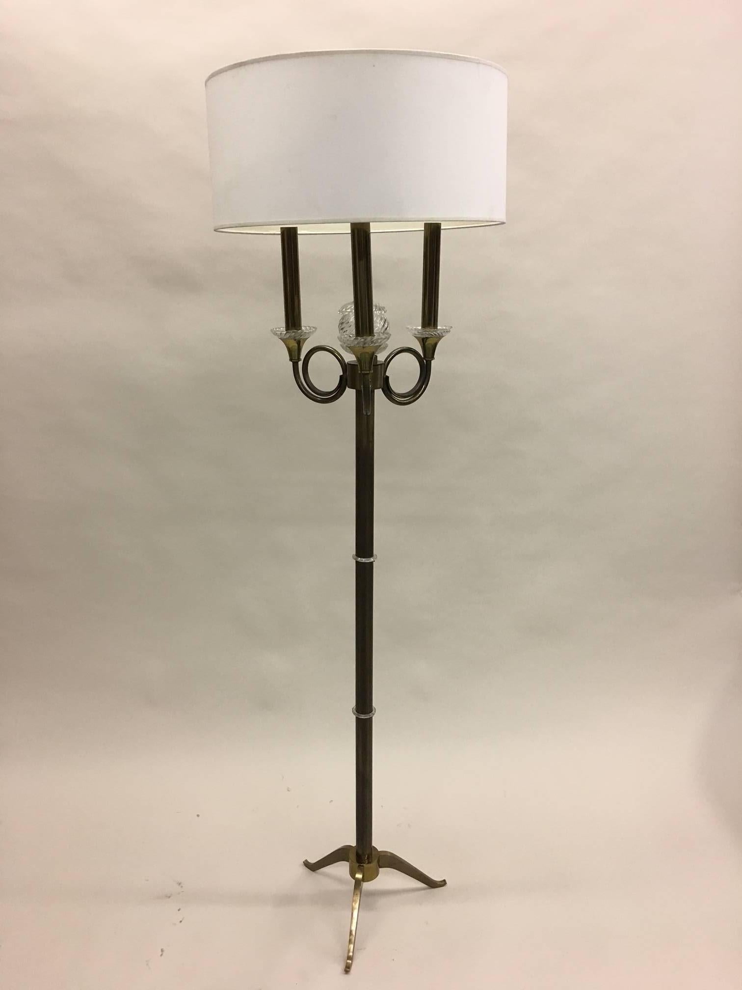 Elegant and timeless pair of French Mid-Century Modern floor lamps by Jules Leleu in solid brass with bronze patina and crystal detailing. The pieces are highlighted with crystal rings around the central column culminating in a crystal or glass ball