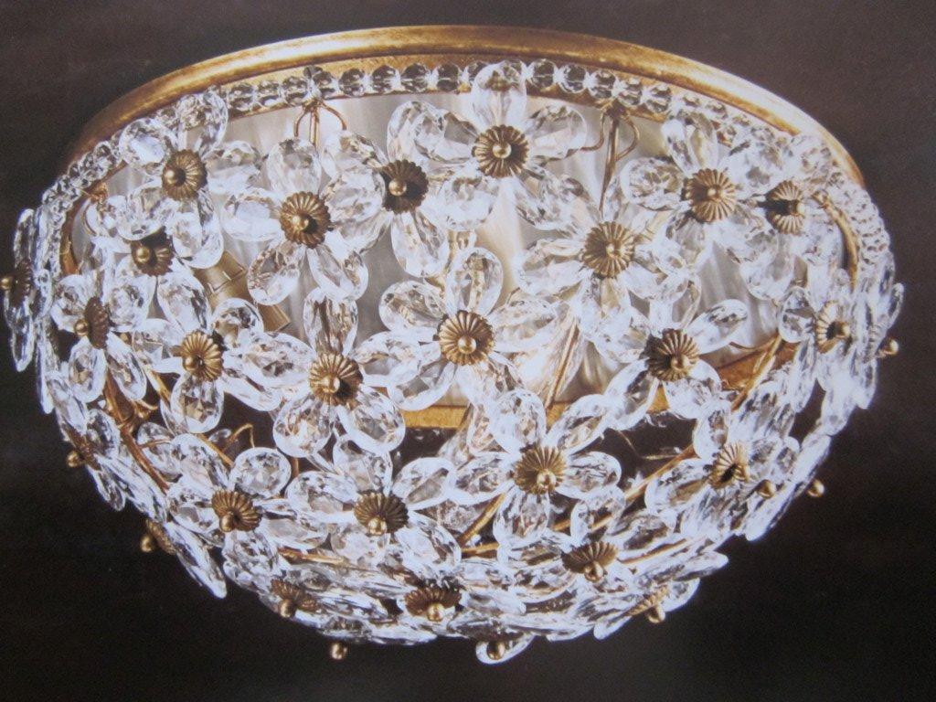 Pair of elegant Italian Mid-Century style flush-mounted ceiling fixtures composed of hand-cut solid Murano glass crystal flowers set in a gold-leafed frame. Each floral pedal is delicately cut. The toning of the gold leaf is soft enhancing the