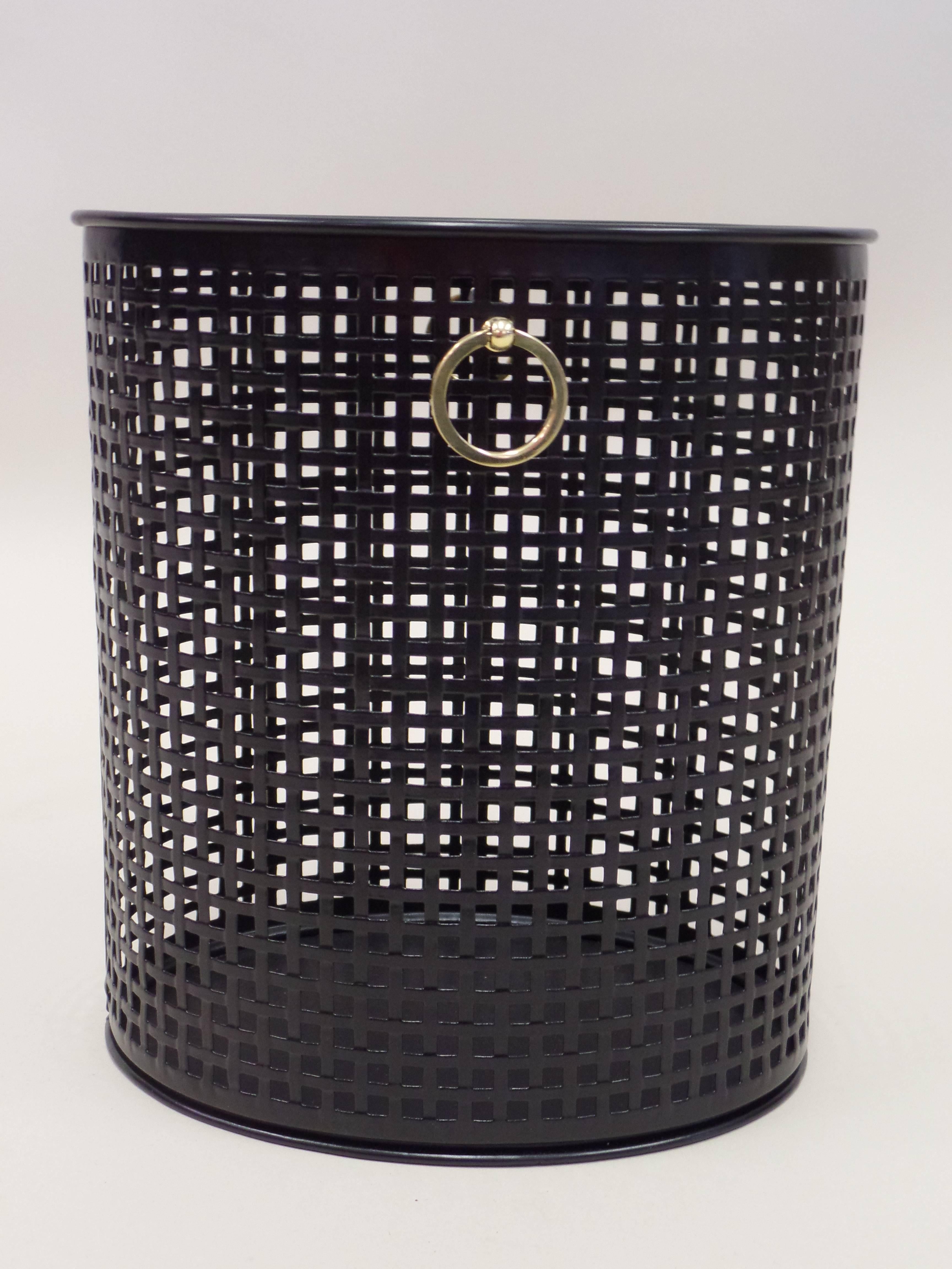 Elegant and timeless French Mid-Century Modern Neoclassical Wastebasket Attributed to Jacques Adnet. 

The piece is oval in form and the structure is composed of small square forms that form a repetitive Minimalist grid pattern. It is in black