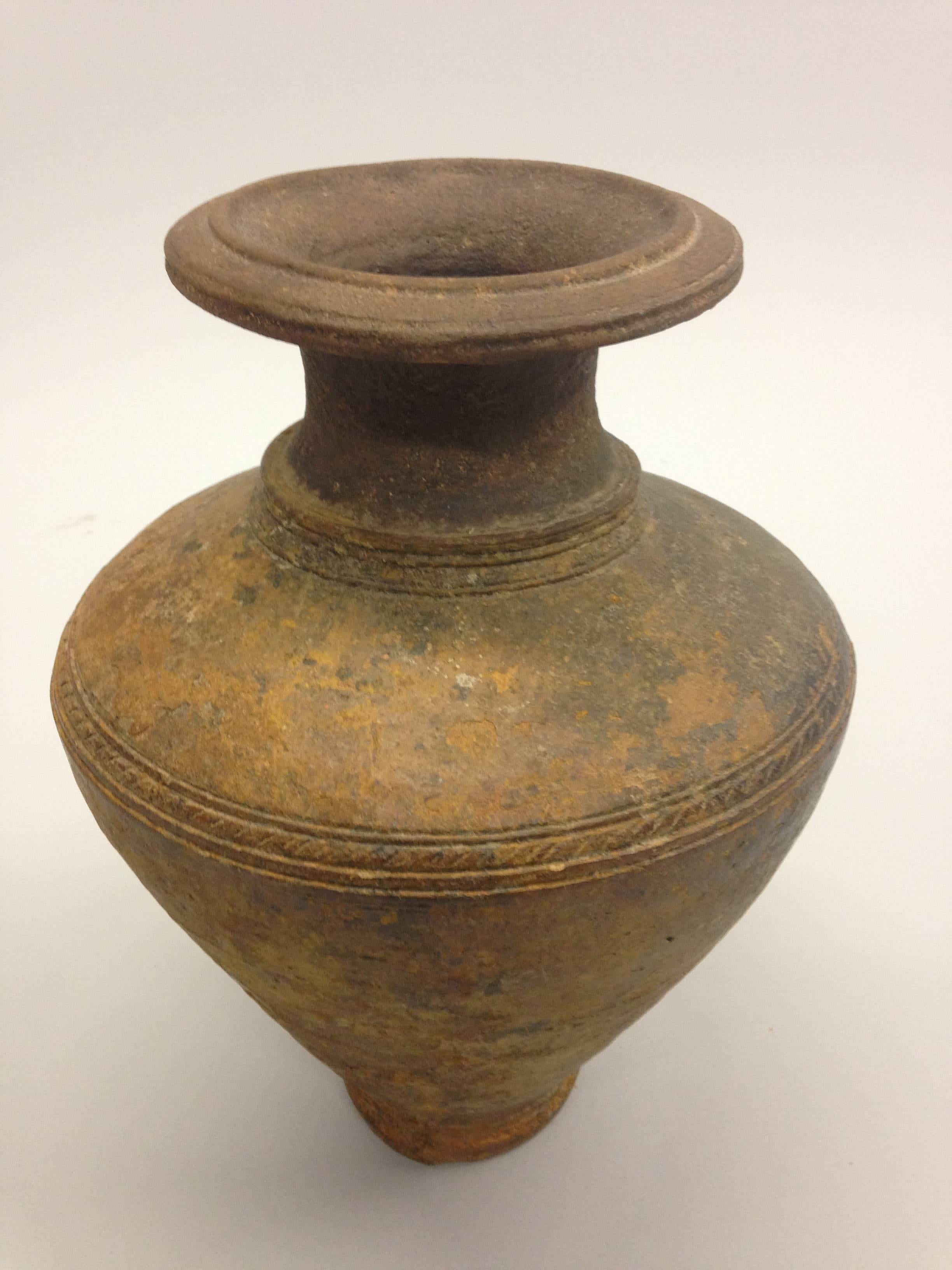 A Khmer urn or vase with a sober, classic form from the Khmer region of ancient Cambodia. Classic form, sober pieces such as these compliment sober, modern or Mid-Century Modern settings very well. 

References: Ancient Art, Sculpture and Objects,