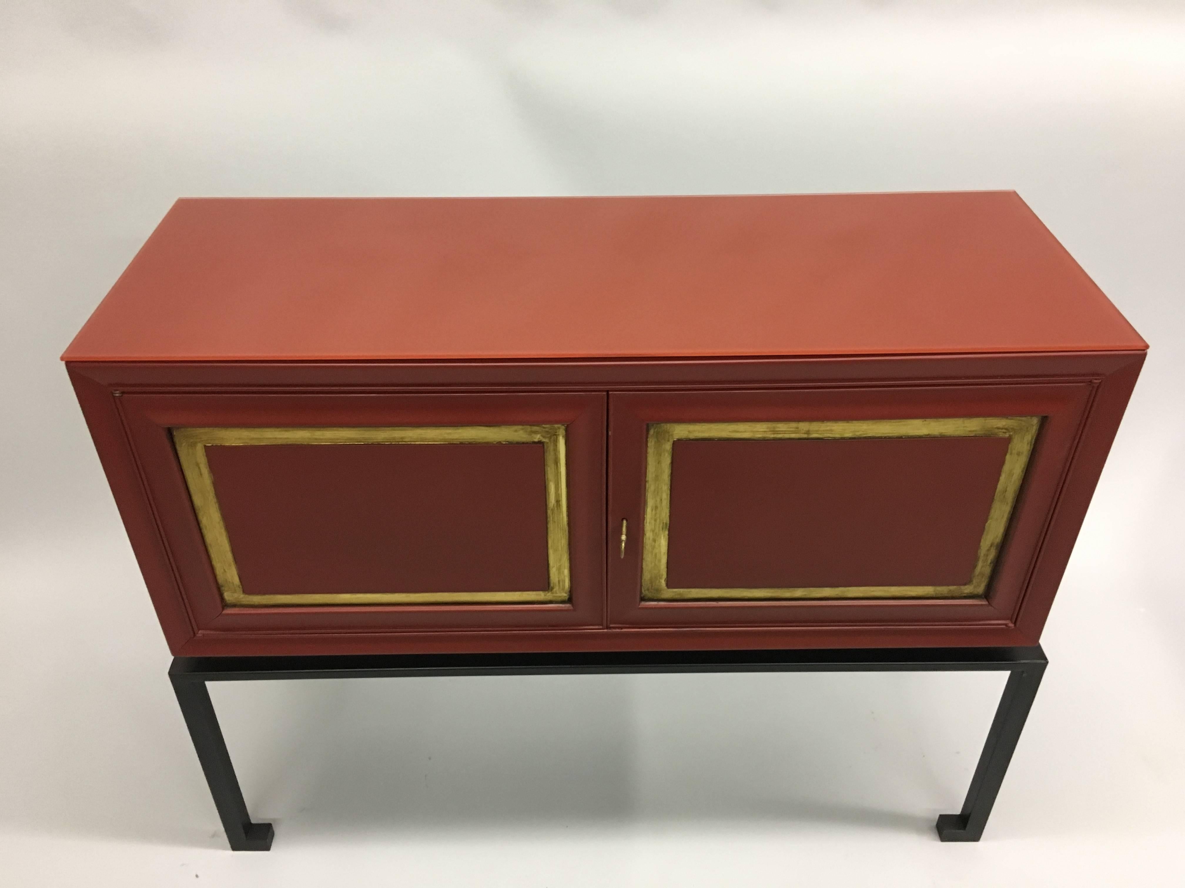 Two Rare and Exceptional French Mid-Century Modern Neoclassical Sideboards in Chinese red lacquer with Chinese red glass tops by Jacques Adnet, France, 1940-1950. The cabinets have pure lines and an exquisite form. They possess a vibrant red color