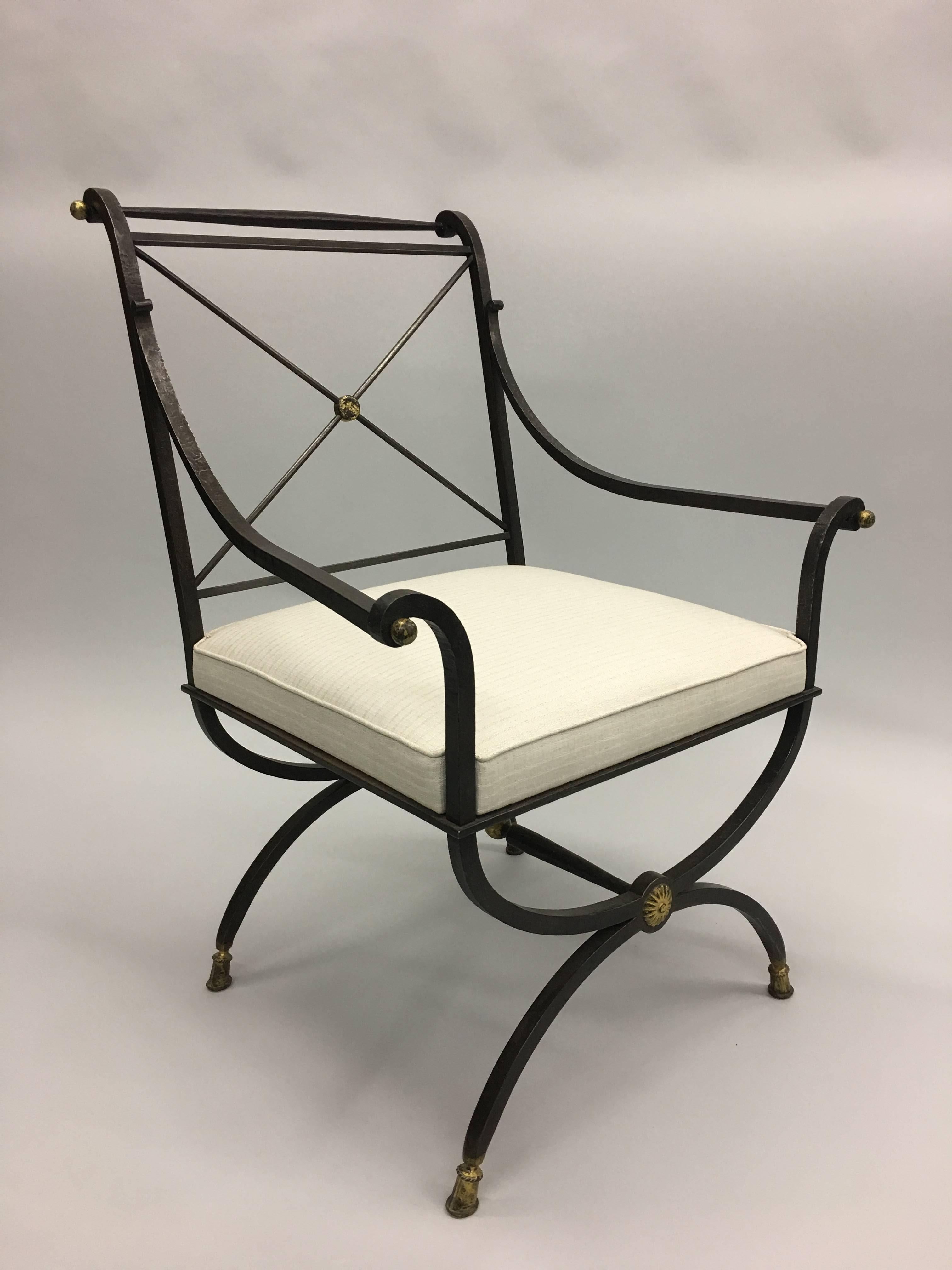 Elegant French modern neoclassical form hand-hammered wrought iron chair for desk, vanity or lounge by Gilbert Poillerat with the seat structure from a design by Andre Arbus.

The chair features a Classic Curile form (rounded X-form) leg