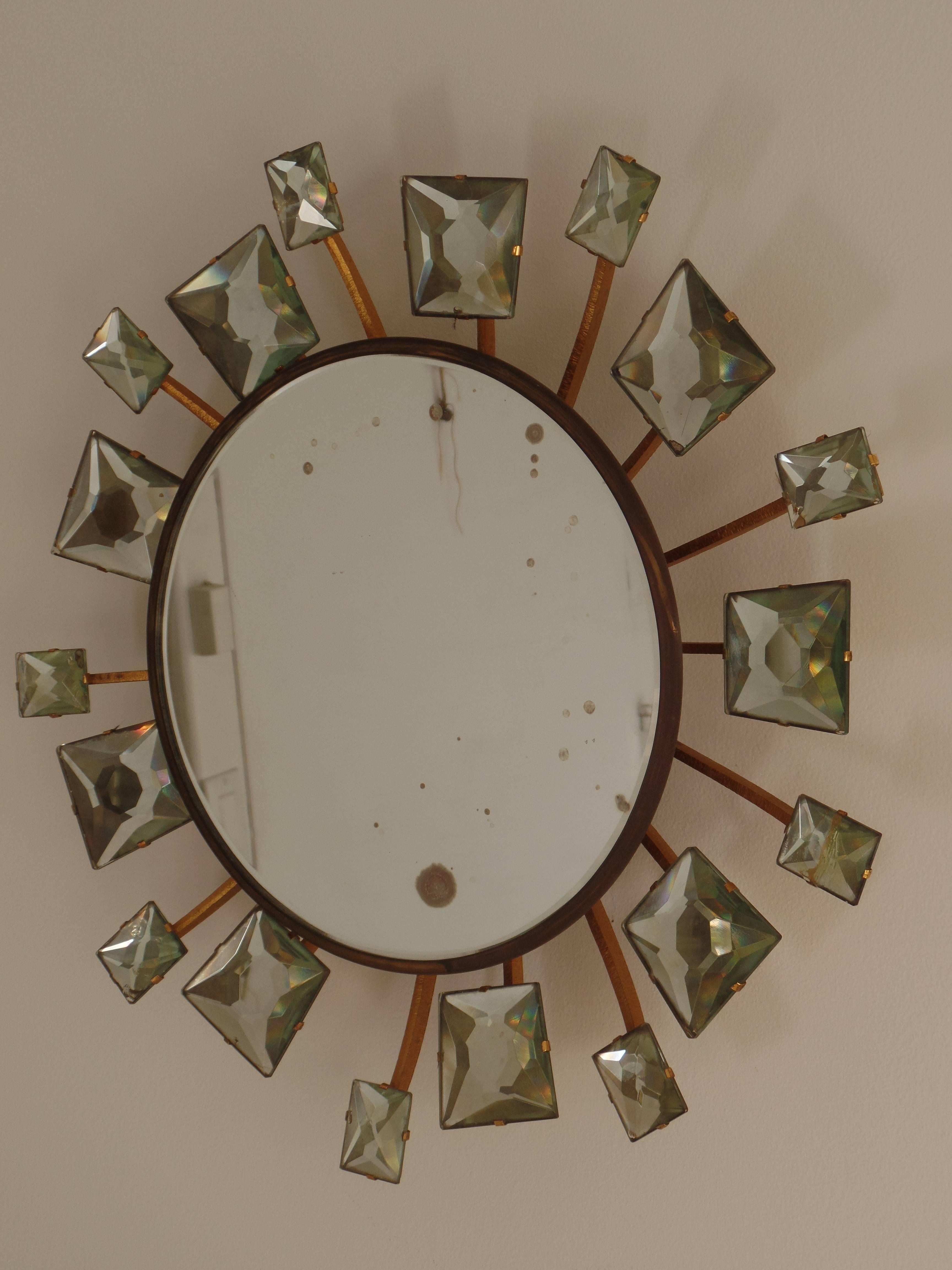 Rare Italian Mid-Century mirror with a round central panel surrounded by 18 delicately chisel cut smaller mirrors, each faceted to gilt iron stems forming a composition of a sunburst/starburst. Each smaller mirror is thick and hand cut into