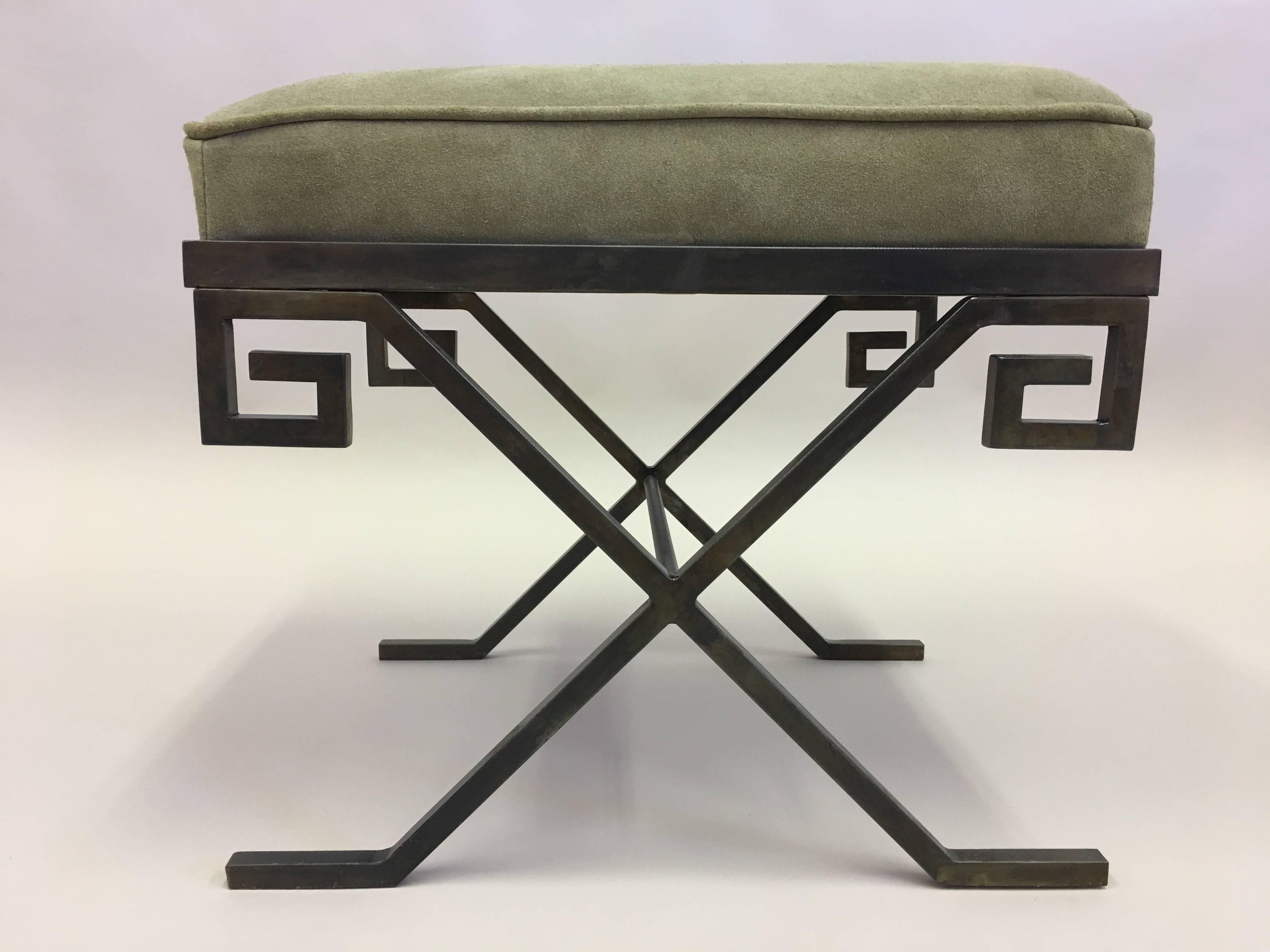 Elegant pair of stools or benches in bronzed wrought iron in the modern neoclassical taste of Jean Michel Frank. The wrought iron frame is in the Classic X-form and the apron is in the form of a Greek key design.

The pieces can be upholstered