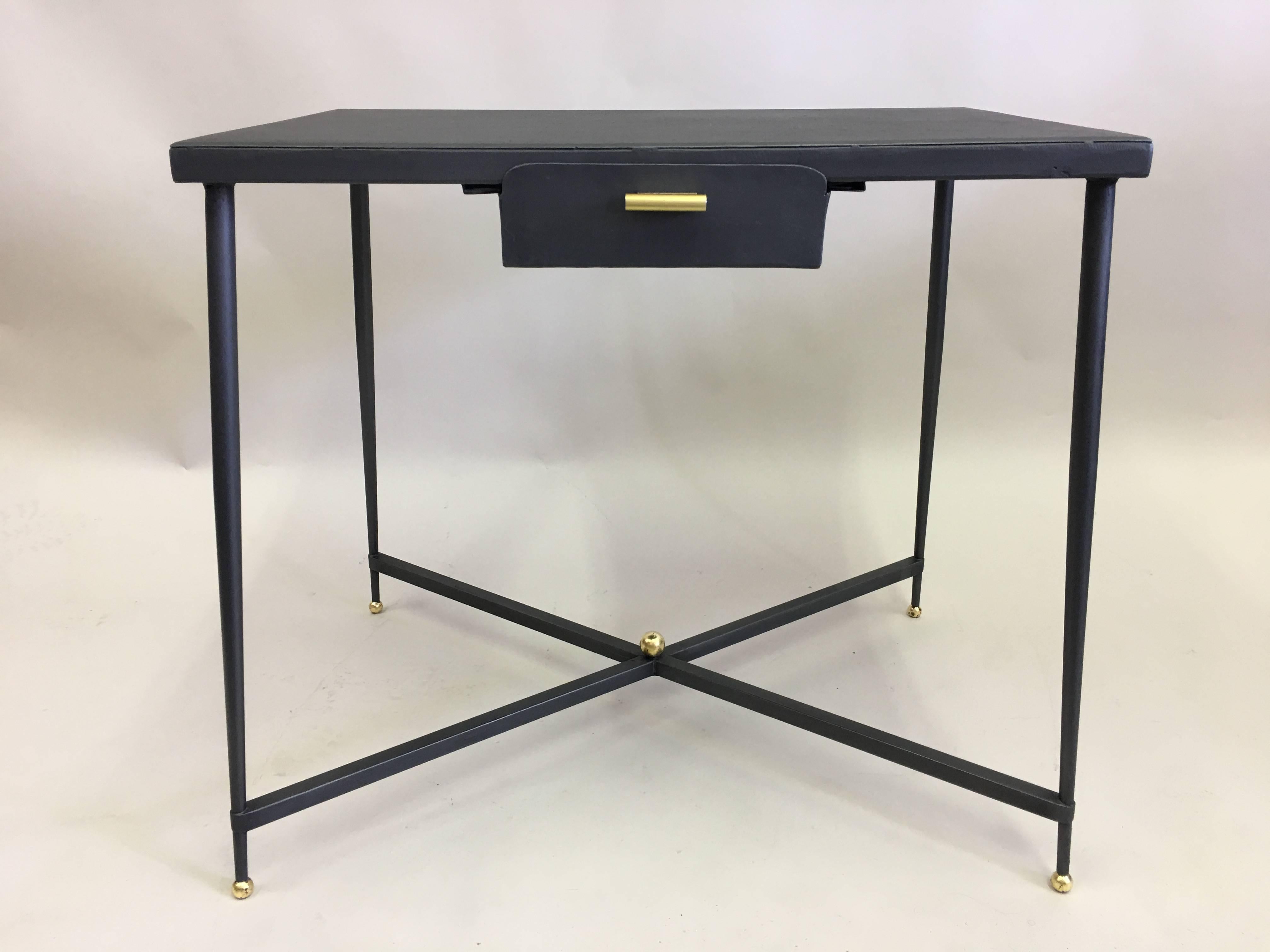 Rare and important French mid-century 1940's desk or writing table by Jacques Adnet symbolizing the iconic Modern Neoclassical nature of French 1940's design. This elegant, sober table is in partially gilt hand wrought iron including a wrought iron